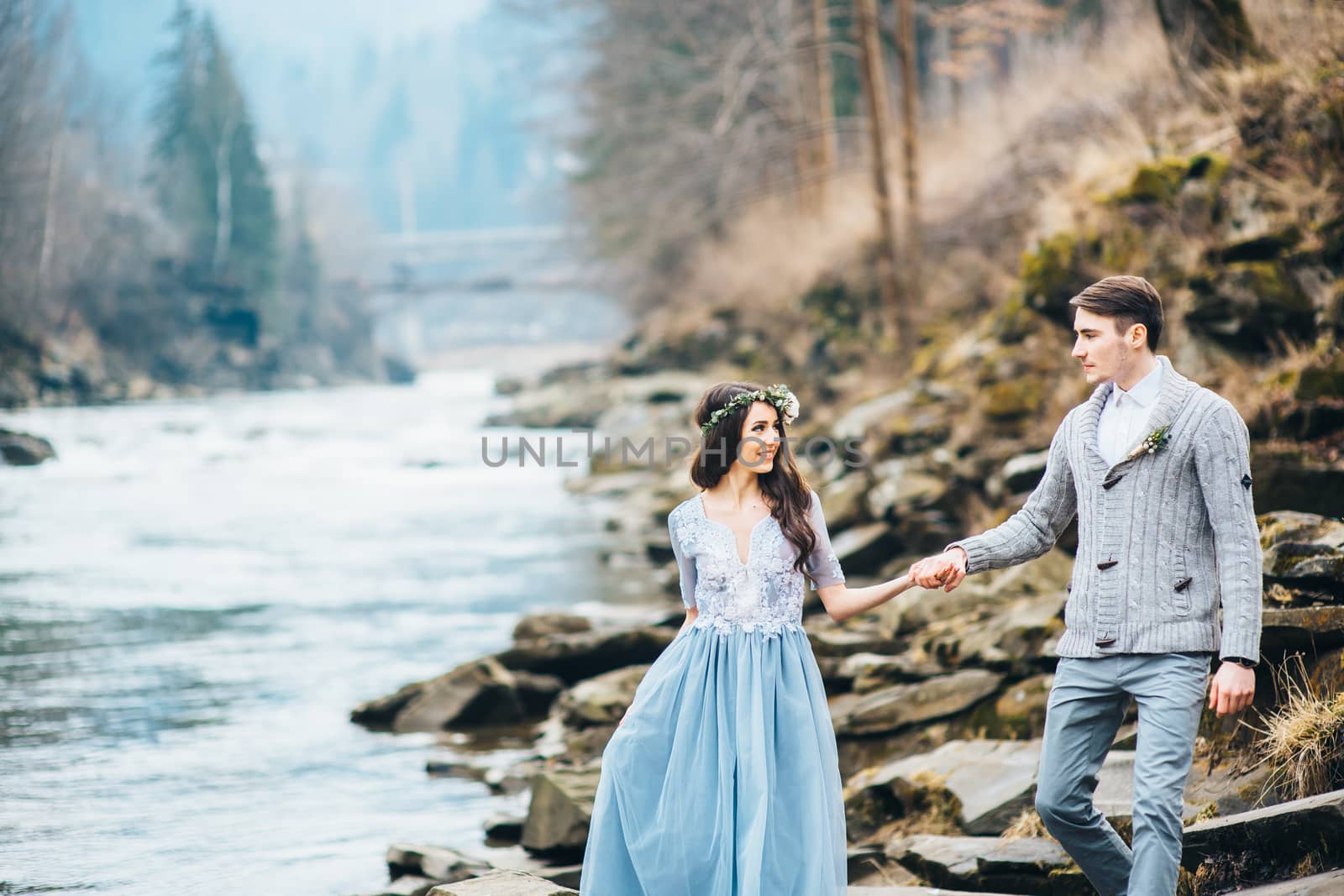 Сouple of newlyweds in the Carpathian waterfall, a wedding walk by Andreua