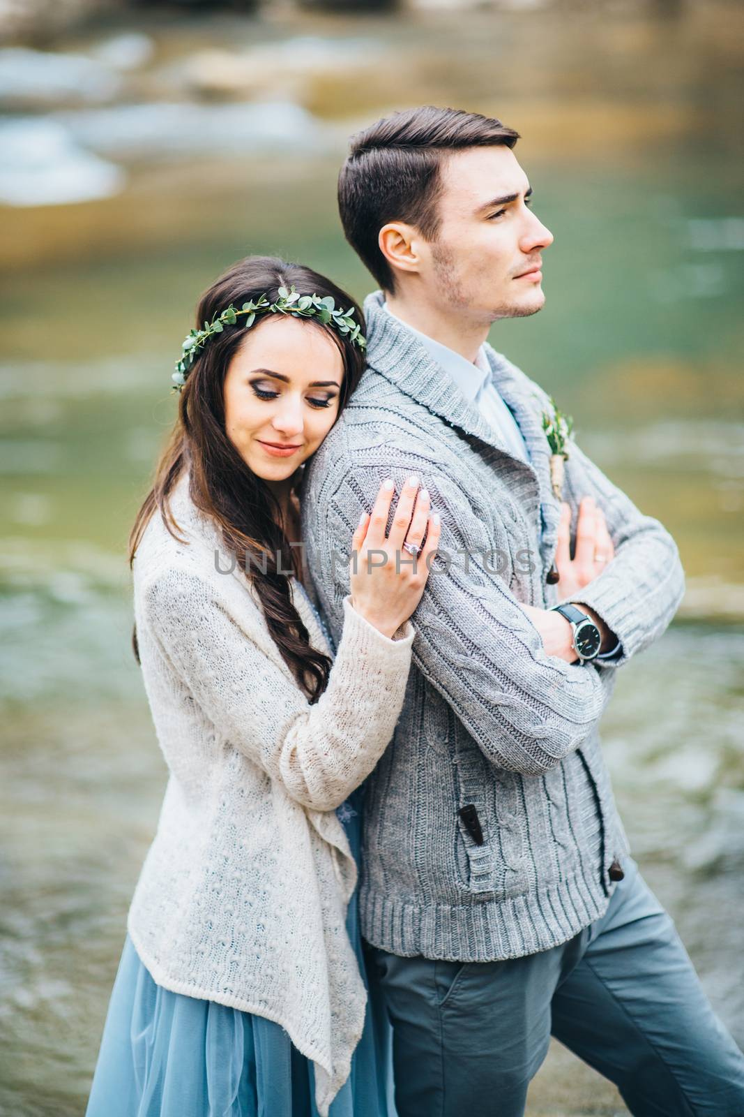 Сouple of newlyweds in the Carpathian waterfall, a wedding walk