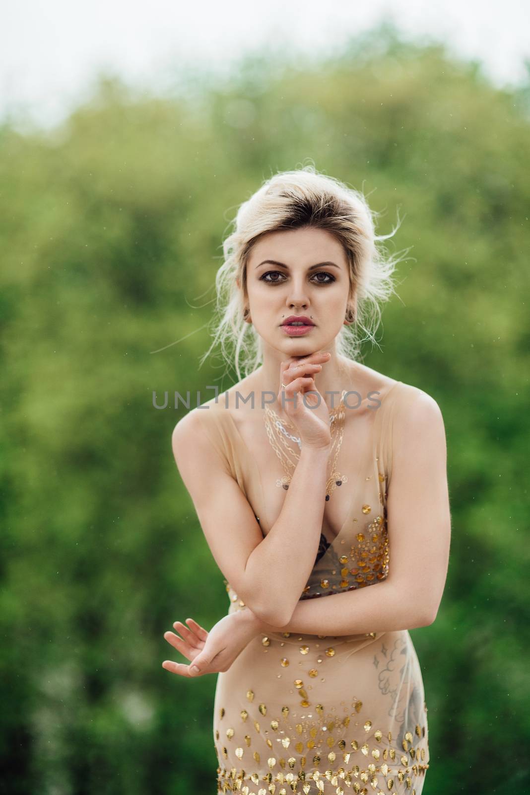 model girl dress gold angel posing in the woods near the old columns