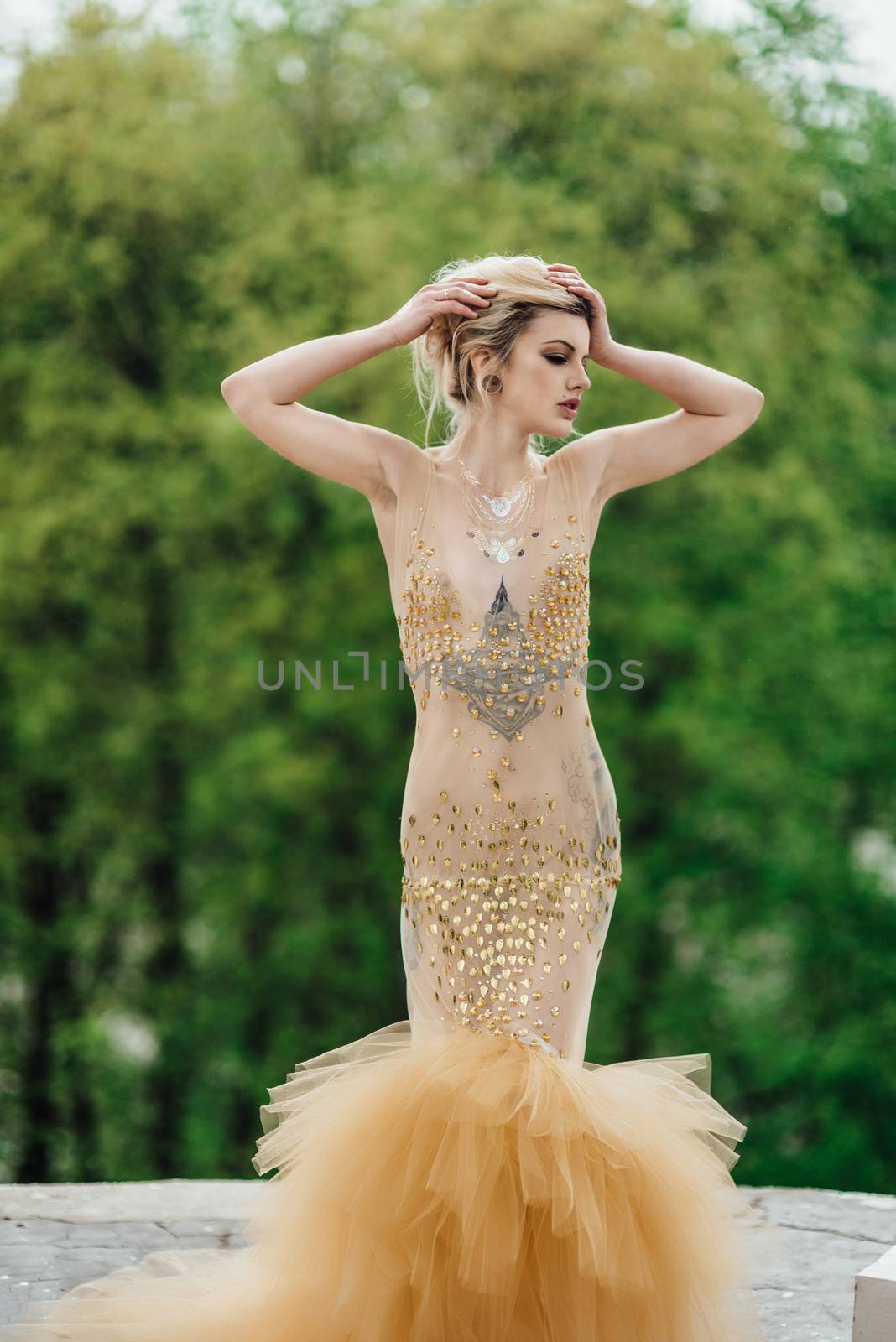 model girl dress gold angel posing in the woods near the old columns