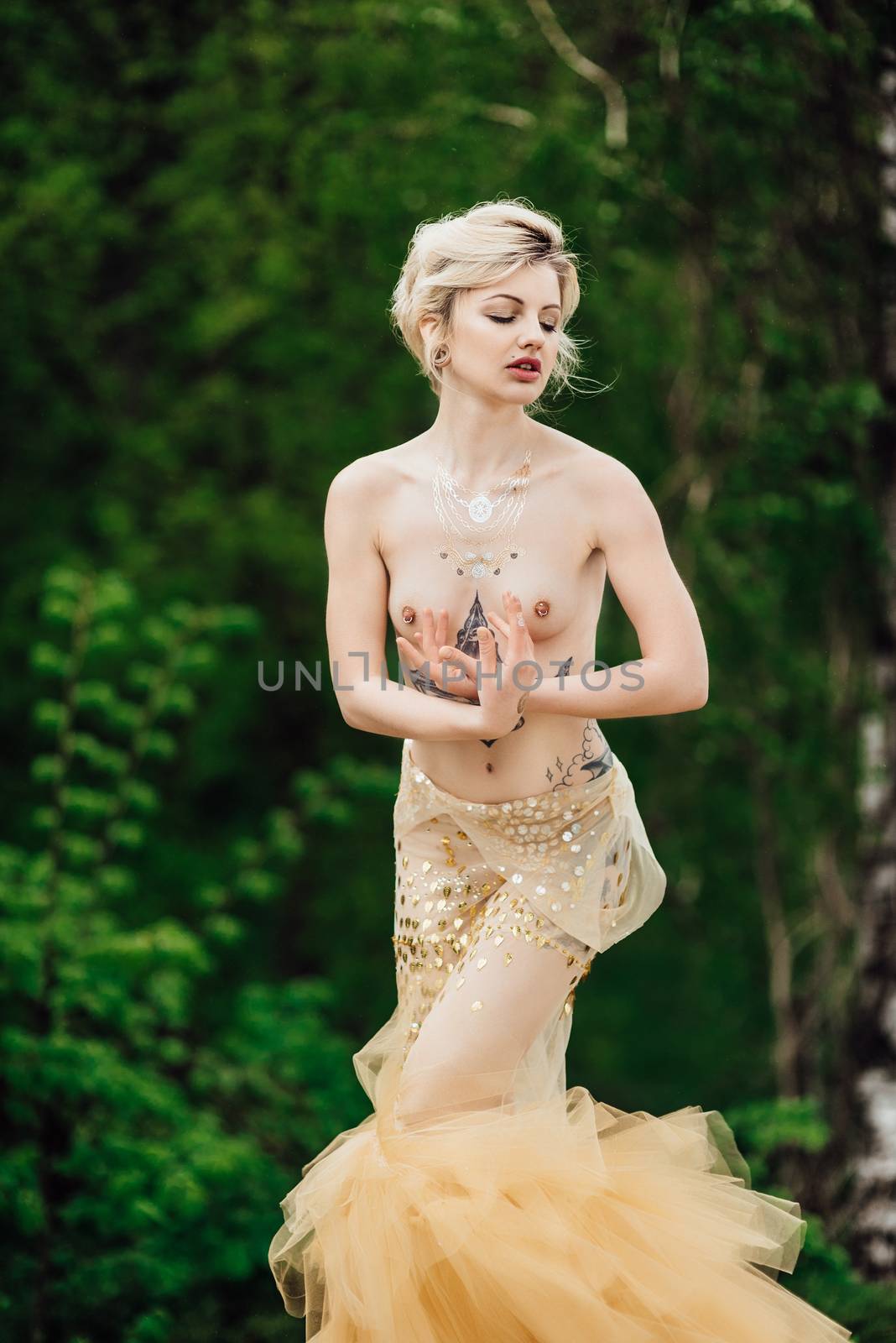 model girl dress gold angel posing in the woods near the old columns