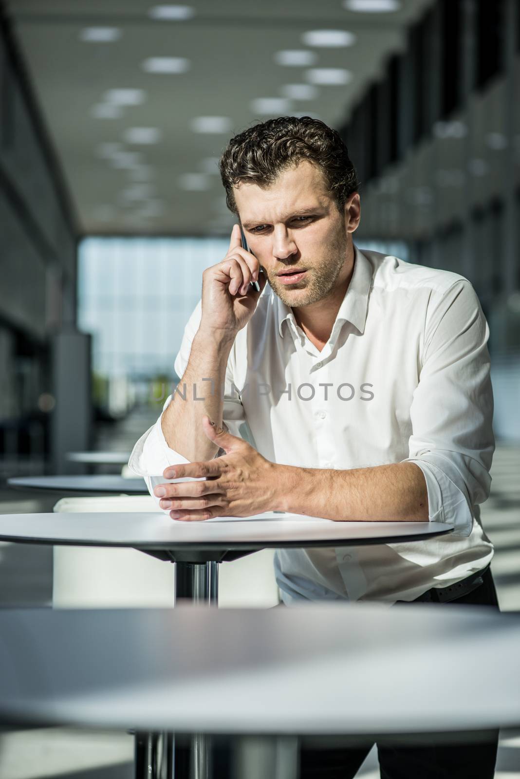 Serious businessman on coffee break by ALotOfPeople