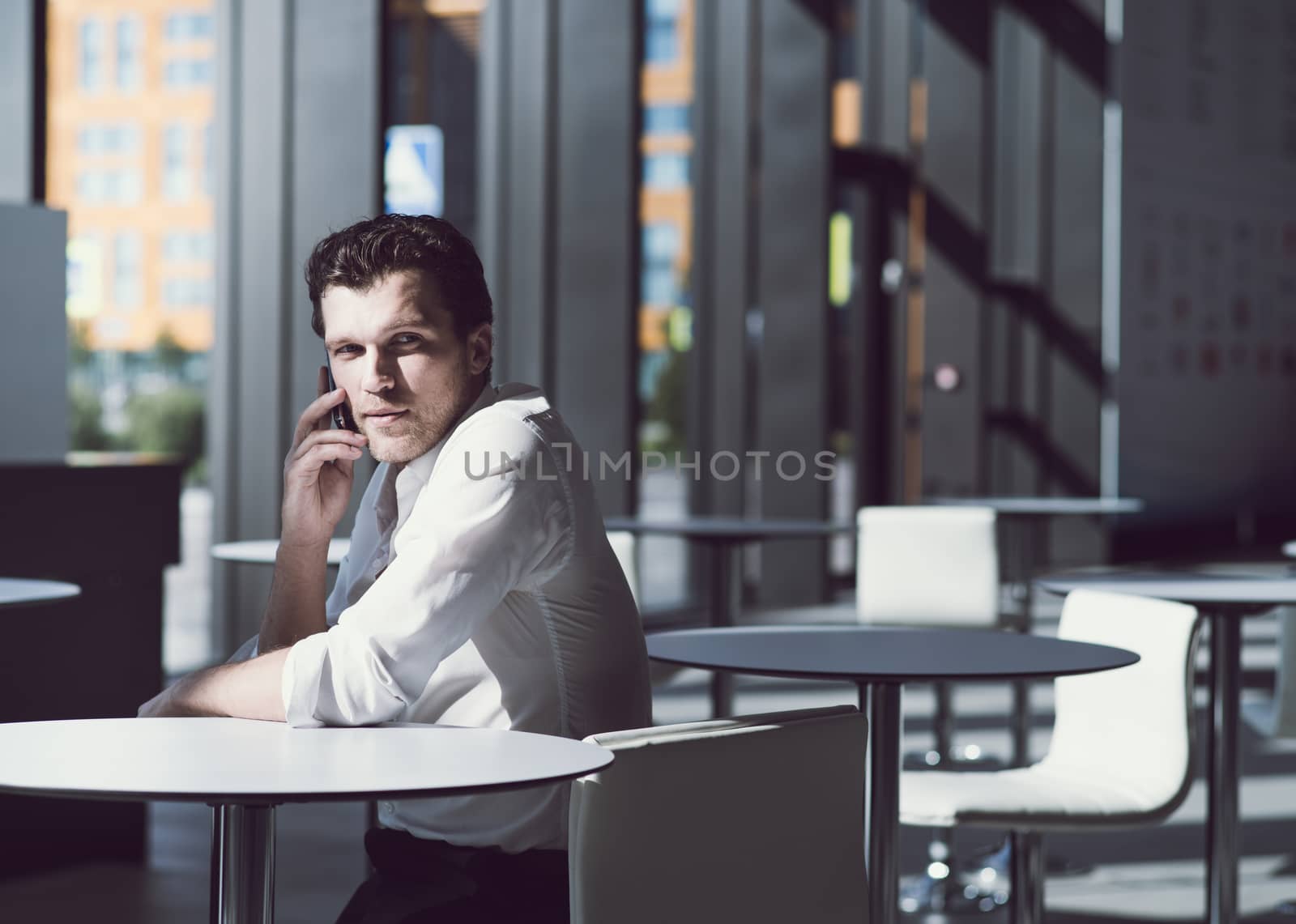 Serious businessman on coffee break by ALotOfPeople