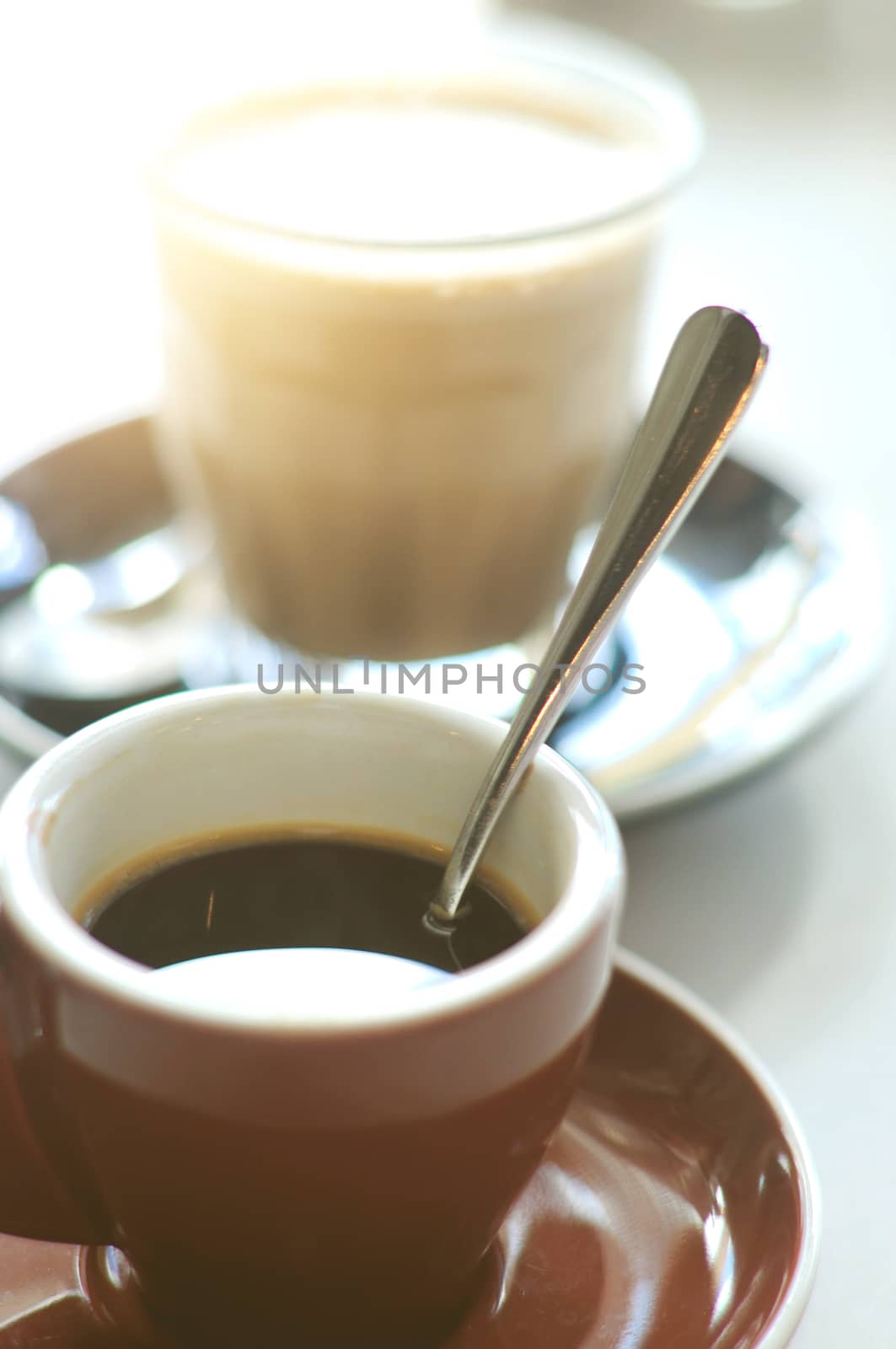 Two cups of espresso and latte coffee on the table