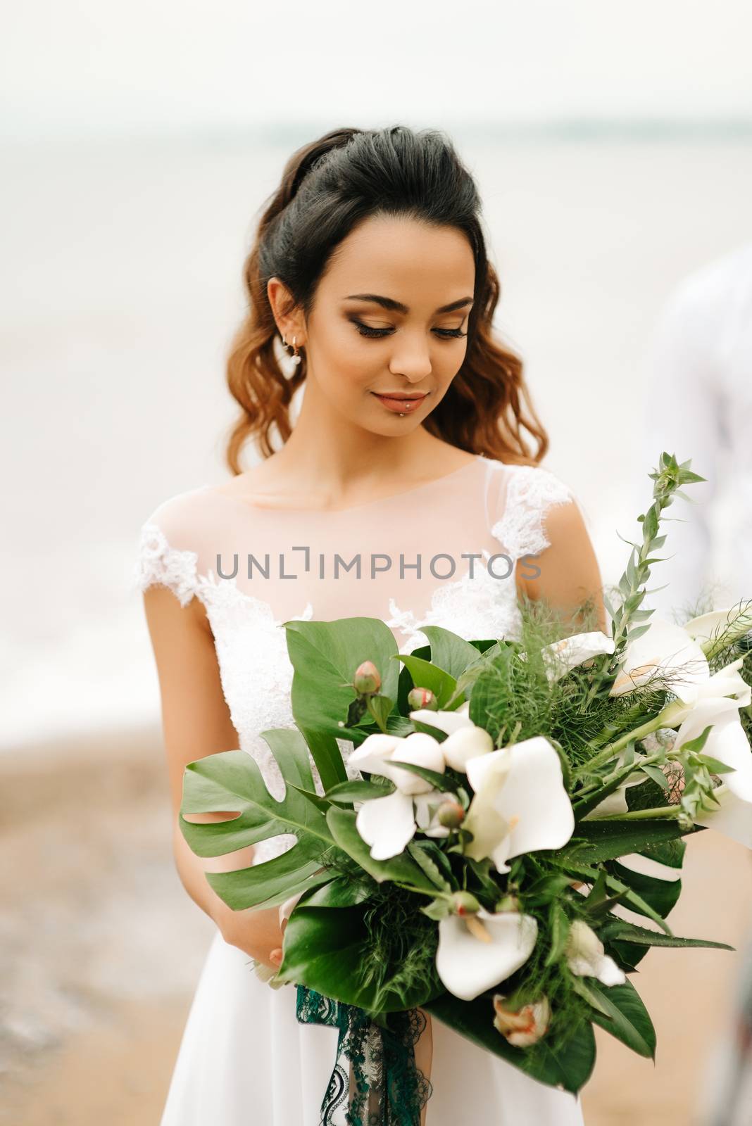 young bride on a sandy beach at a wedding walk