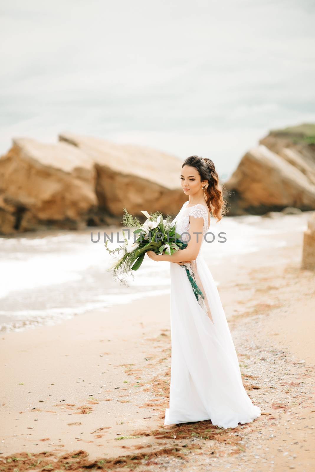 young bride on a sandy beach at a wedding walk