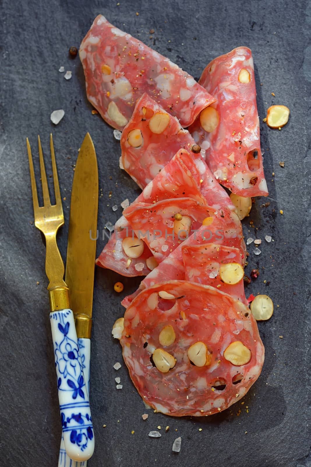 Italian salami with nuts on ardesia plate