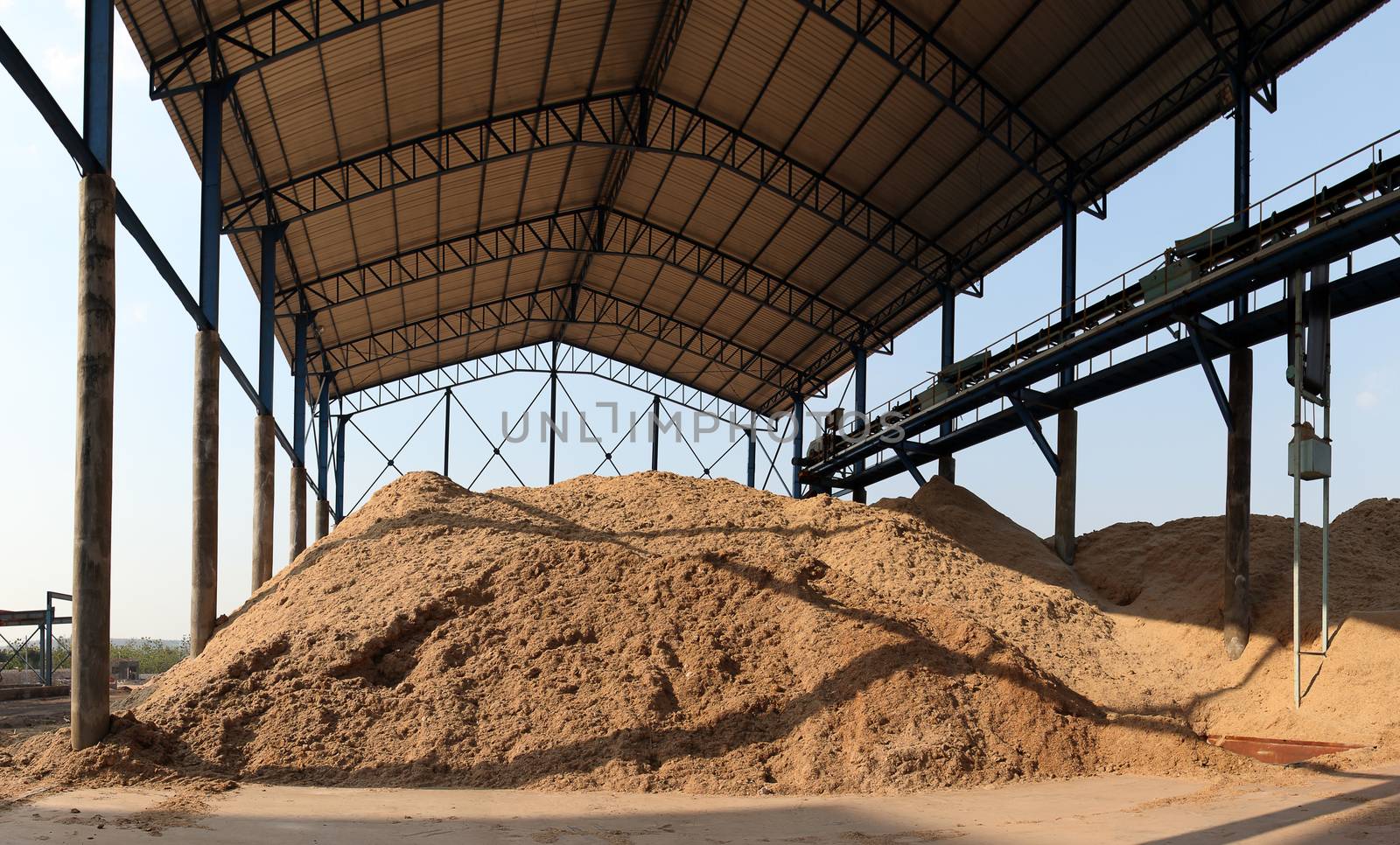 Bagasse stock pile by photosoup