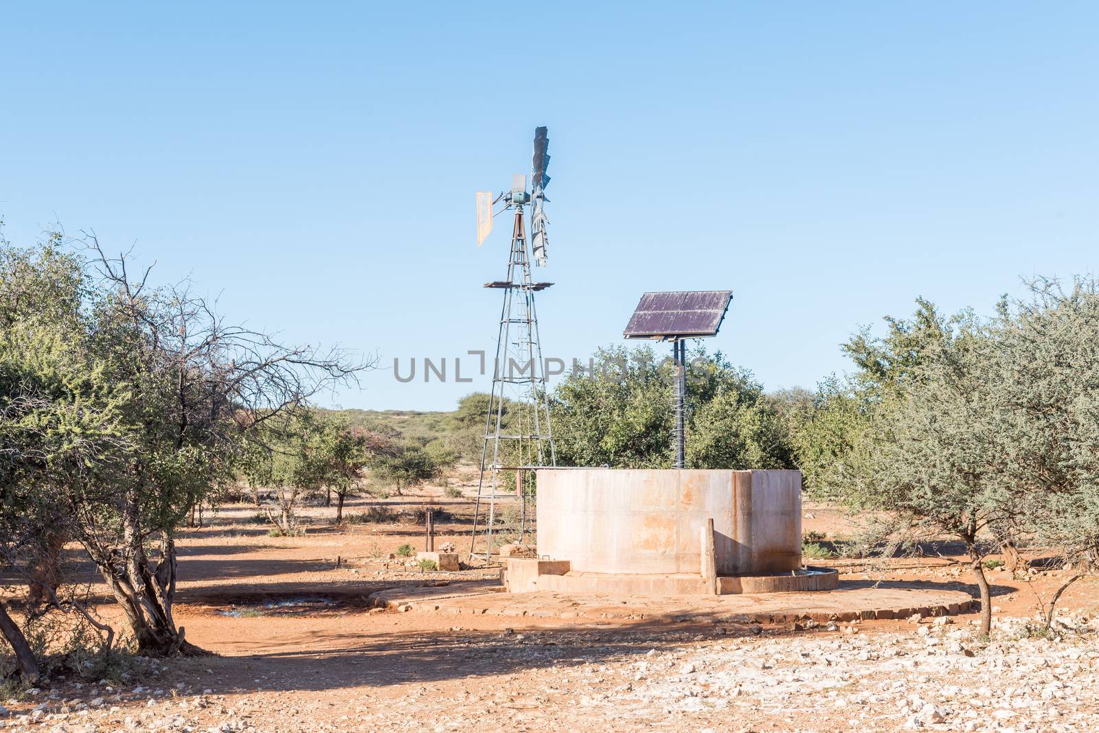 A water-pumping windmill and solar panels for a waterpump near Schmidtsfrift, a village in the Northern Cape Province of South Africa