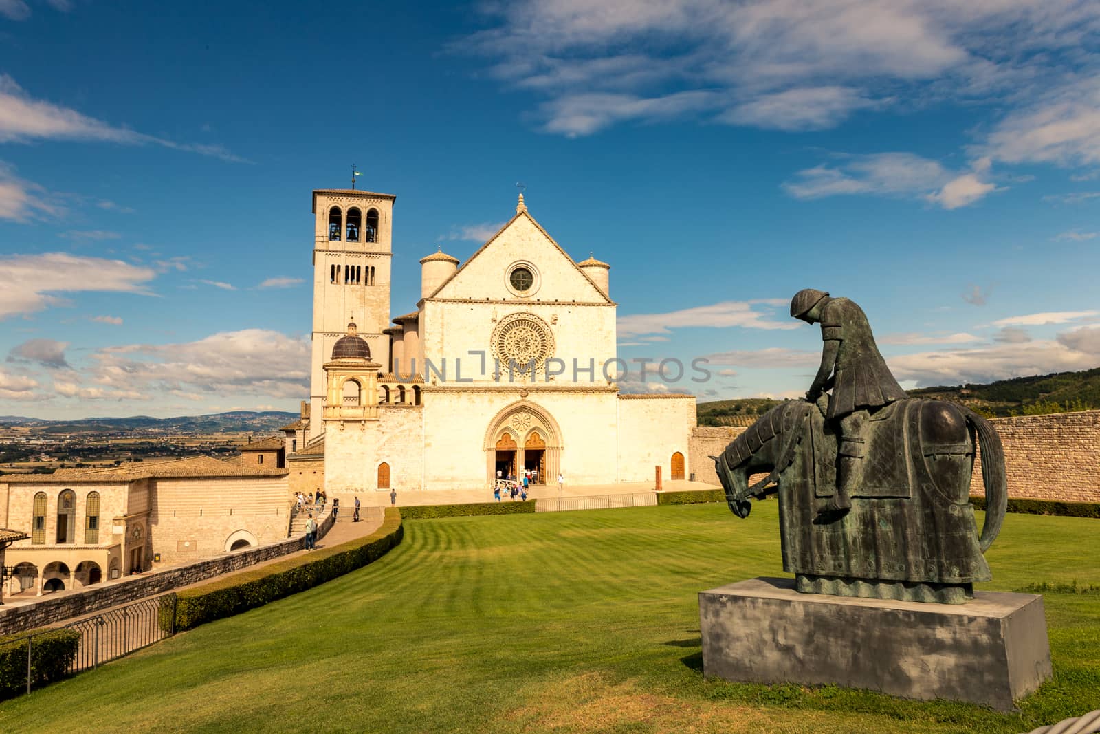 St. Francis of Assisi Church with the statue of St. Francis on a horse in the foreground. St. Francis is the patron saint of Italy. The bell tower can be seen from miles away.