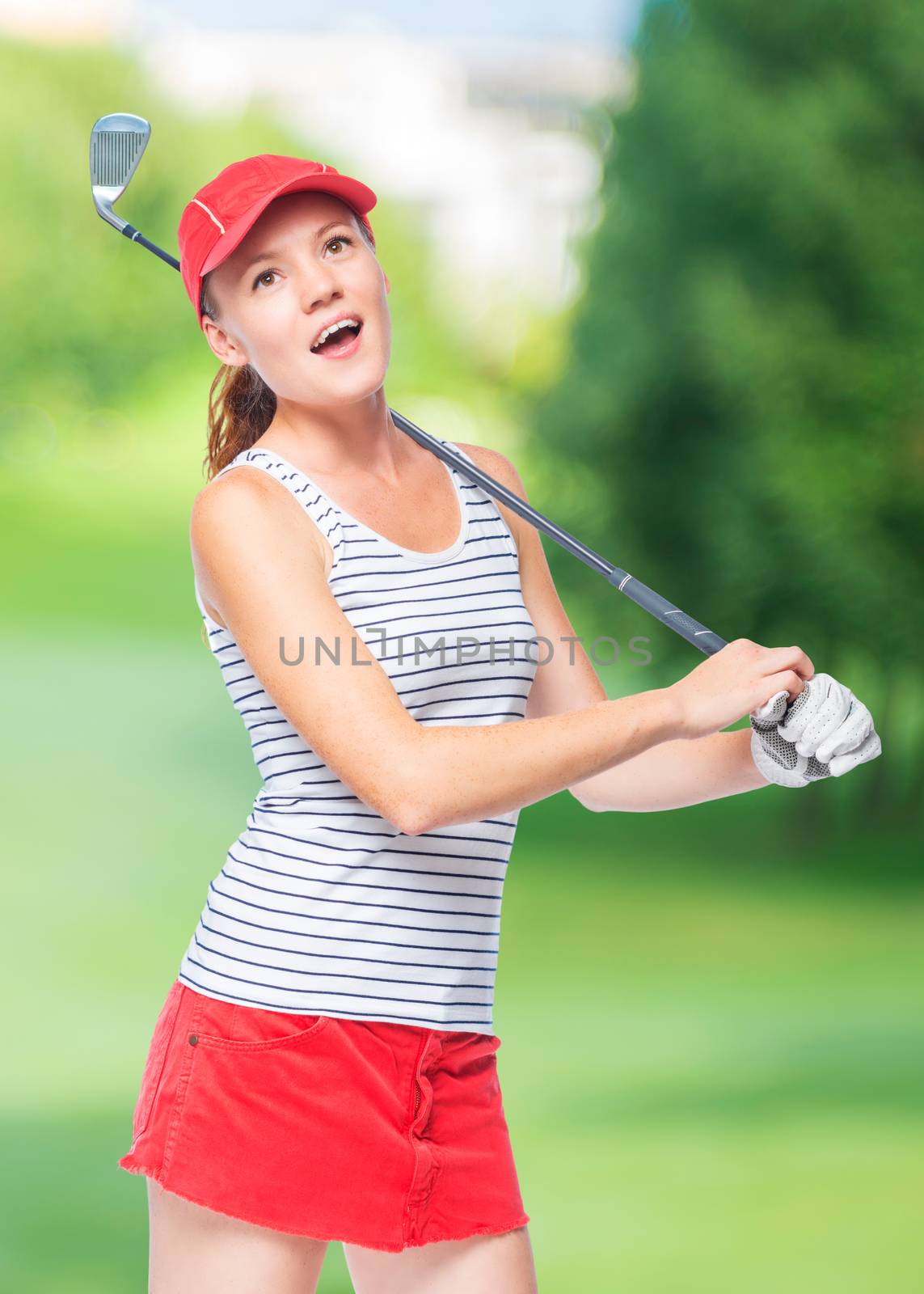 Golfer in cap with golf club on a background of golf courses