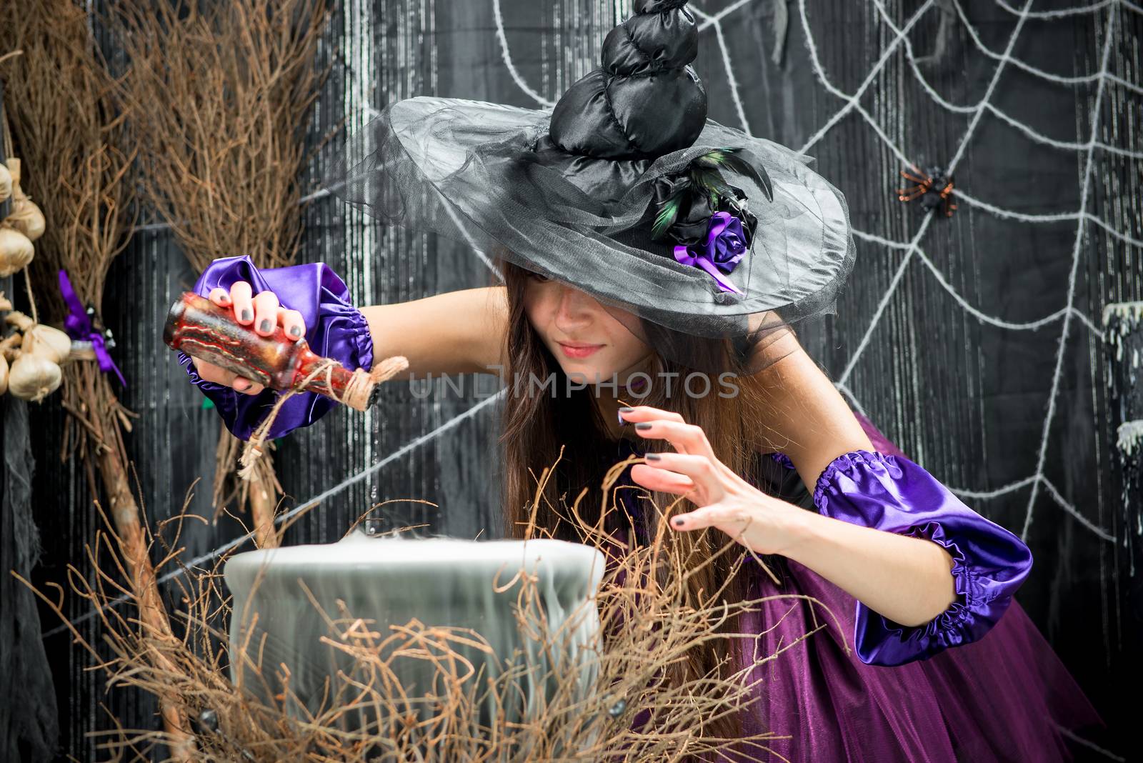 An experienced sorceress poured into a cauldron, a potion from a bottle