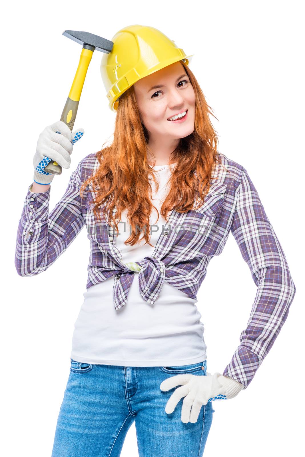 woman with a hammer in a yellow helmet on a white background in the studio