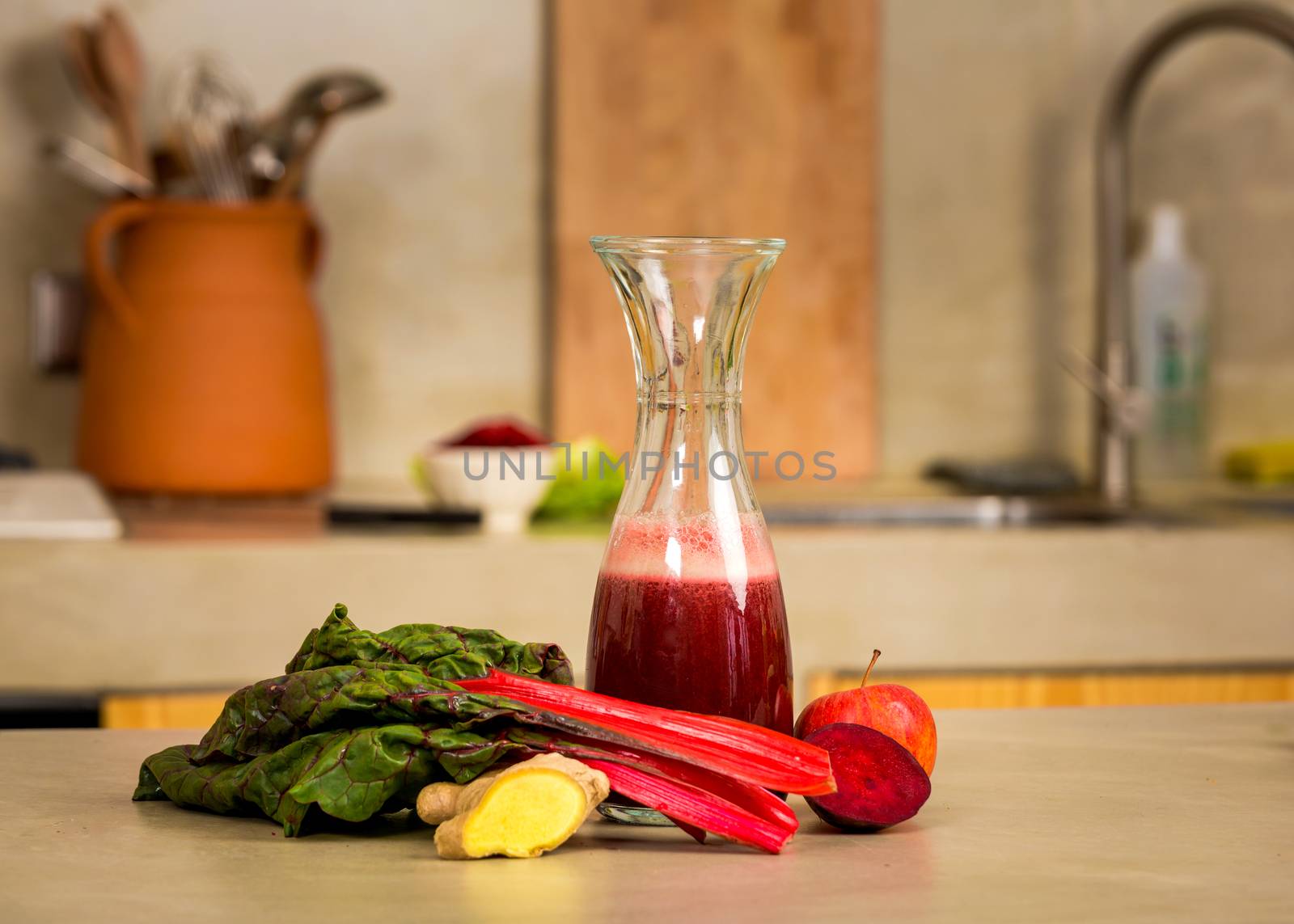 Glass jar of red juice, a detox beverage.  