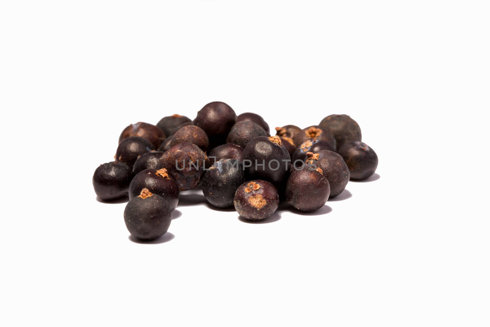 Black pepper grains on white background