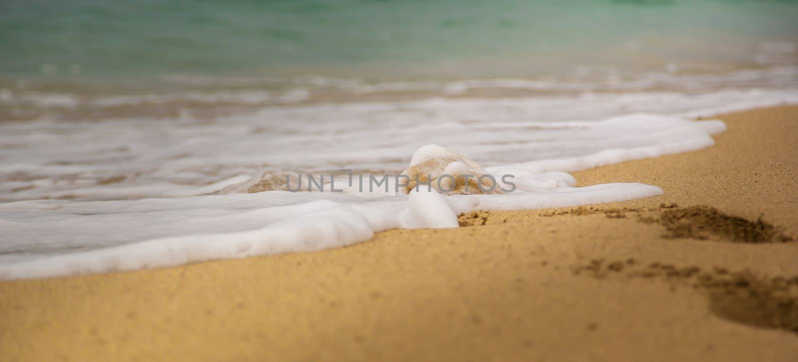 Little wave on a sand beach with traces in the sand by sandra_fotodesign
