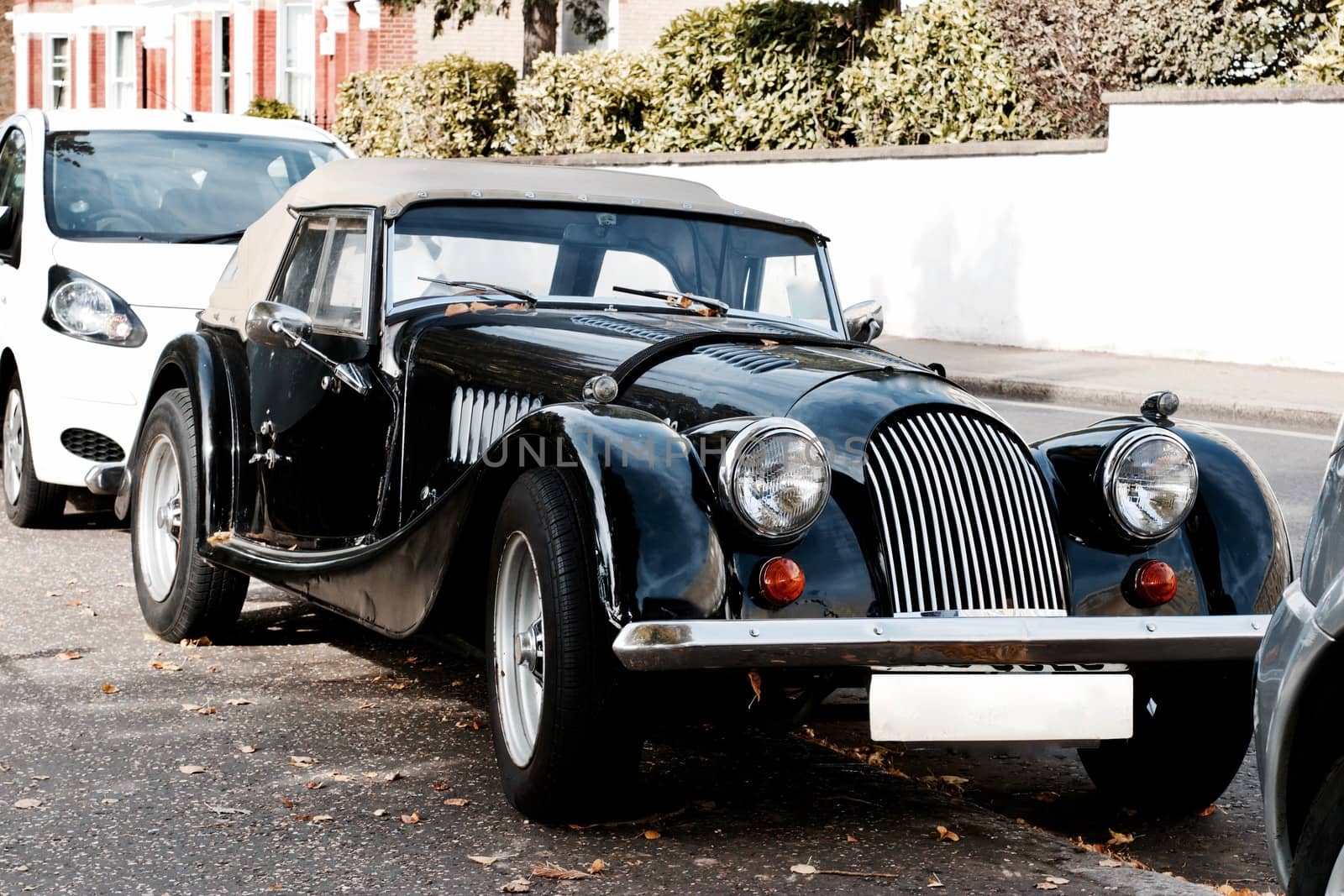 Black old classic car on the road in Richmond, London
