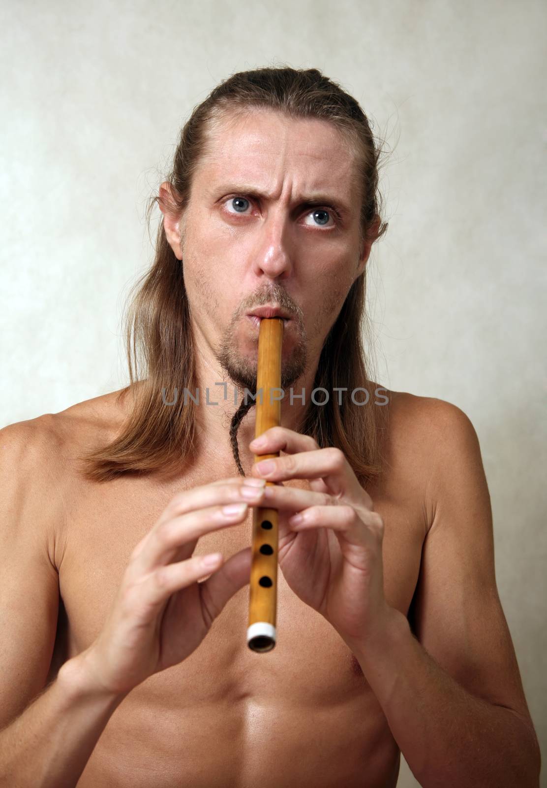 A man playing his wind instrument with expression