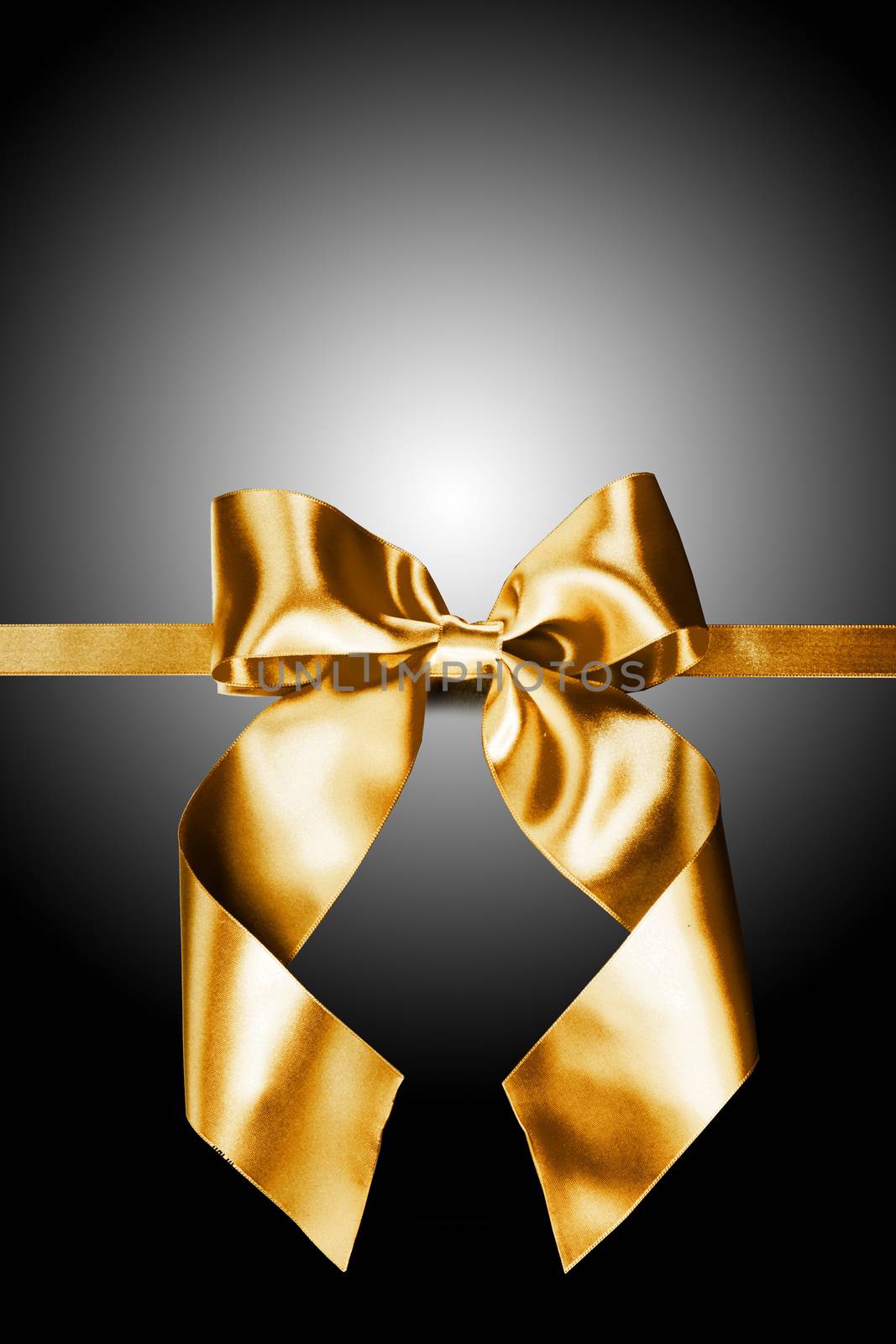 Golden gift ribbon bow on black background