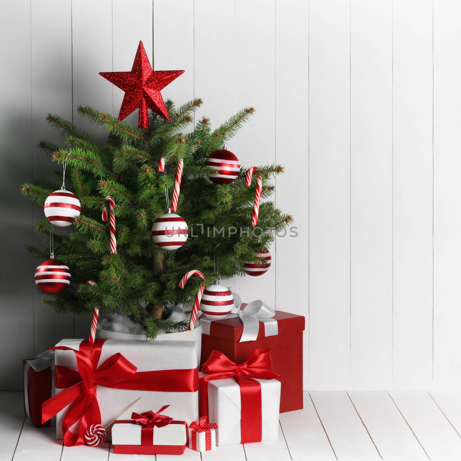 Merry christmas card with decorated christmas tree on white wooden background