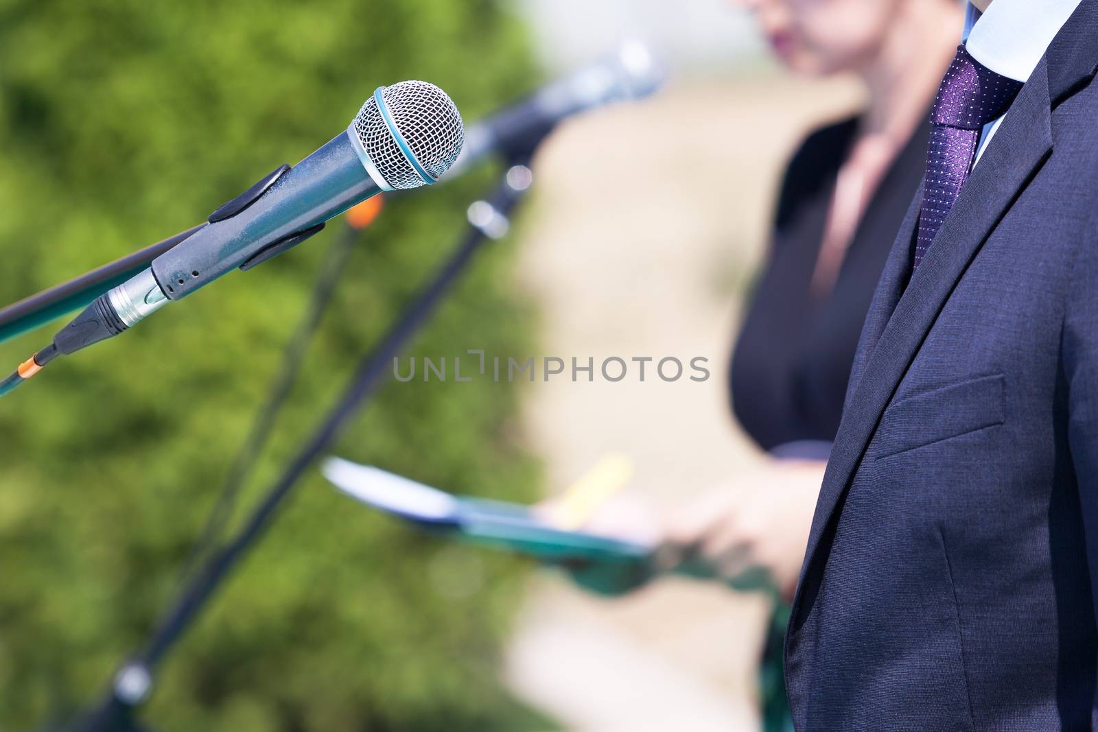 Speaker. Speech. Microphone. News conference. by wellphoto