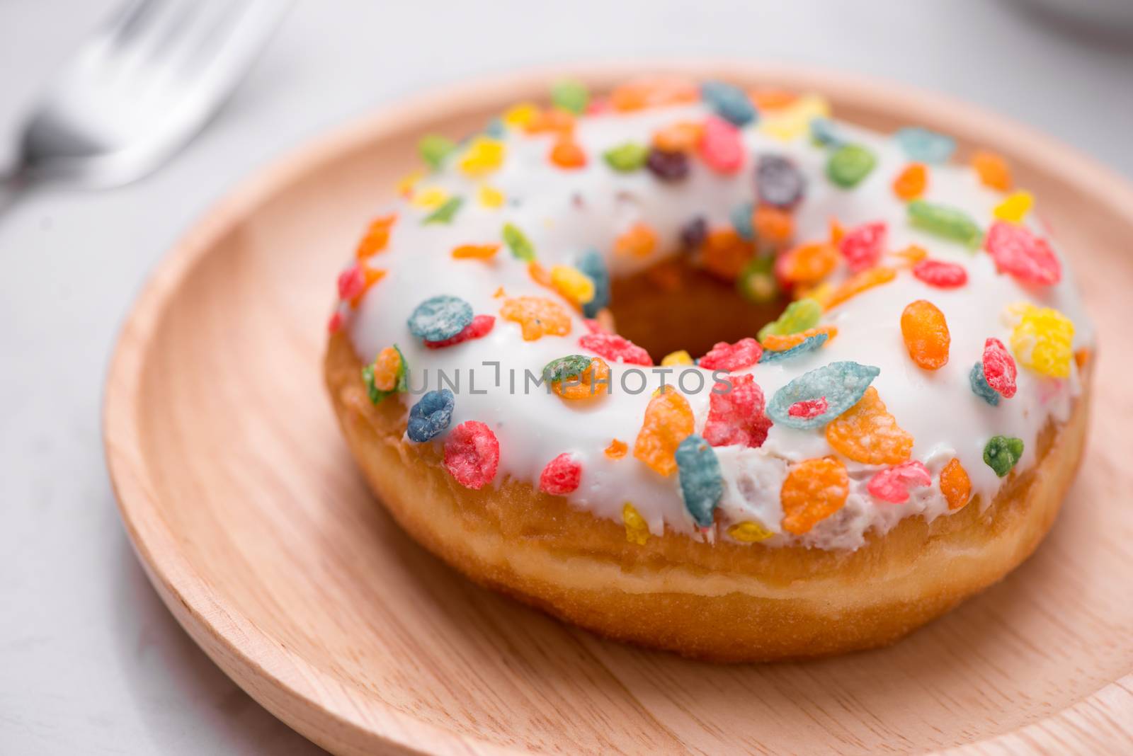Plate with delicious donuts on marble background.