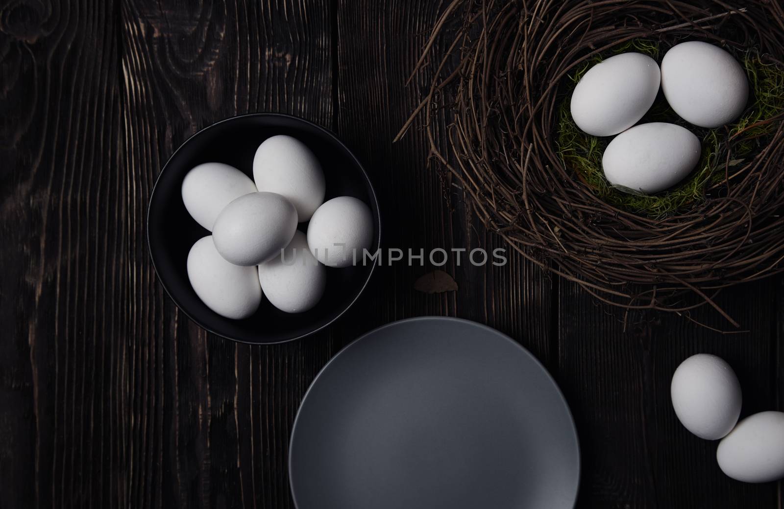 Easter eggs and bird nest on a rustic wooden table