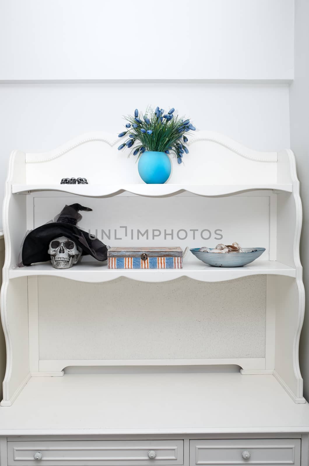 Human skull in a white cabinet. Halloween theme by Novic
