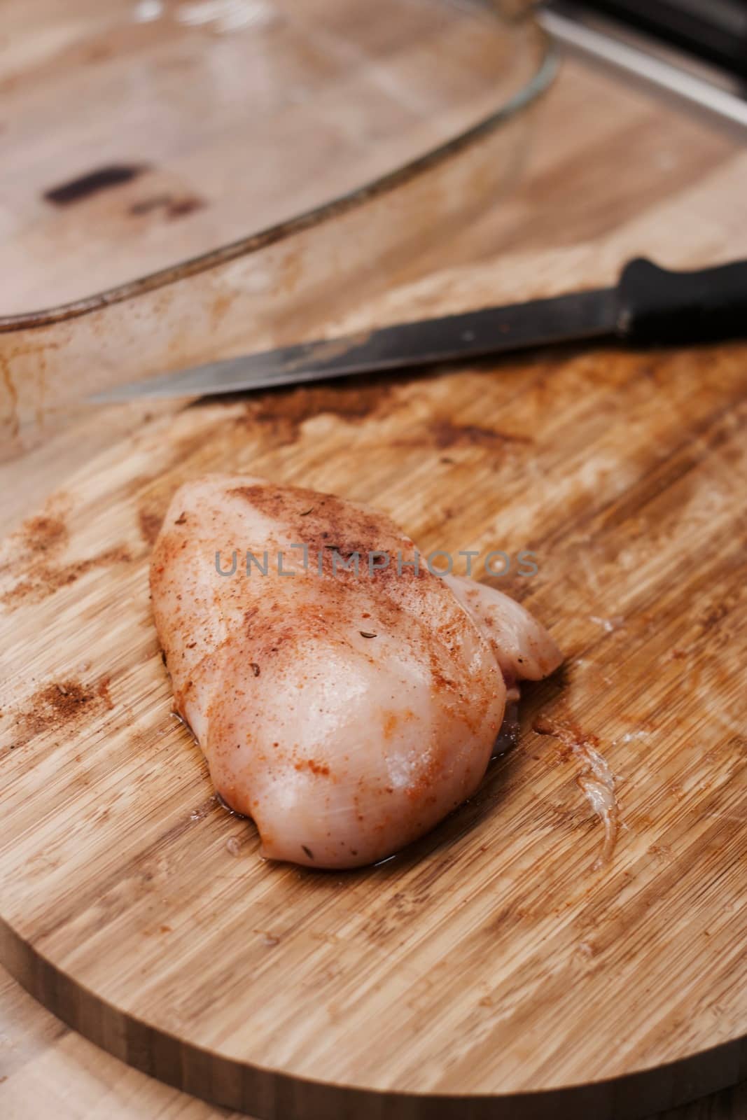 Fresh chicken meat on the wooden board in the kitchen. Home cooking concept.