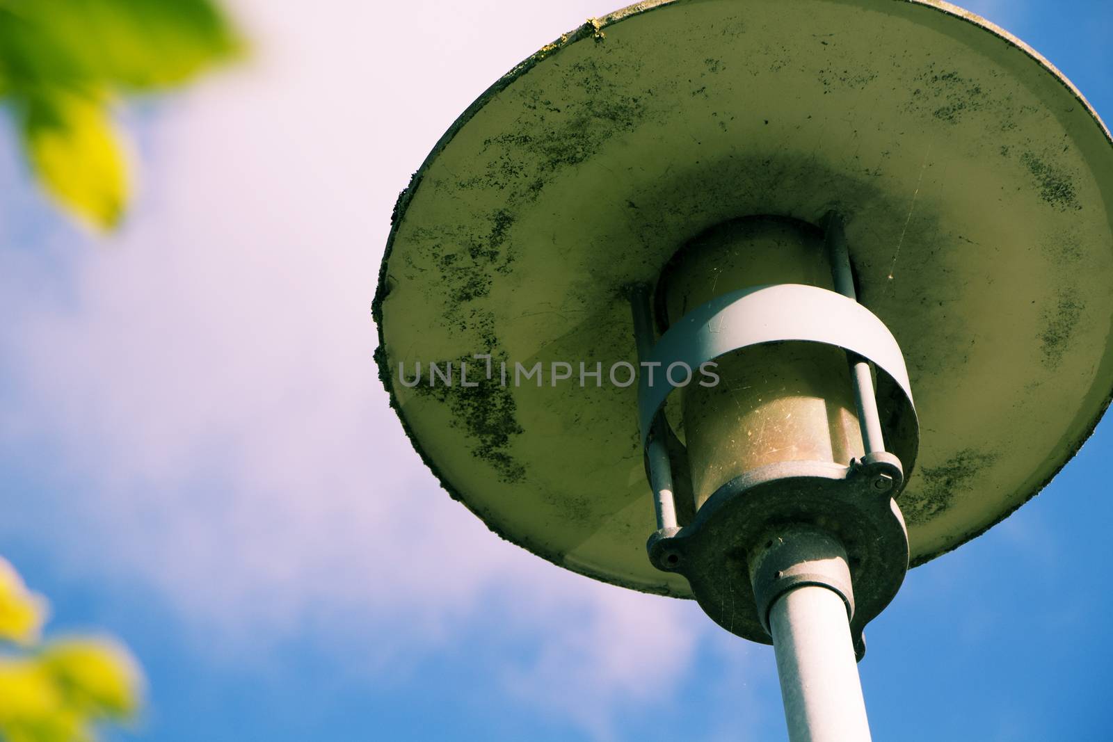 Closeup on lamppost without power on a sunny day.