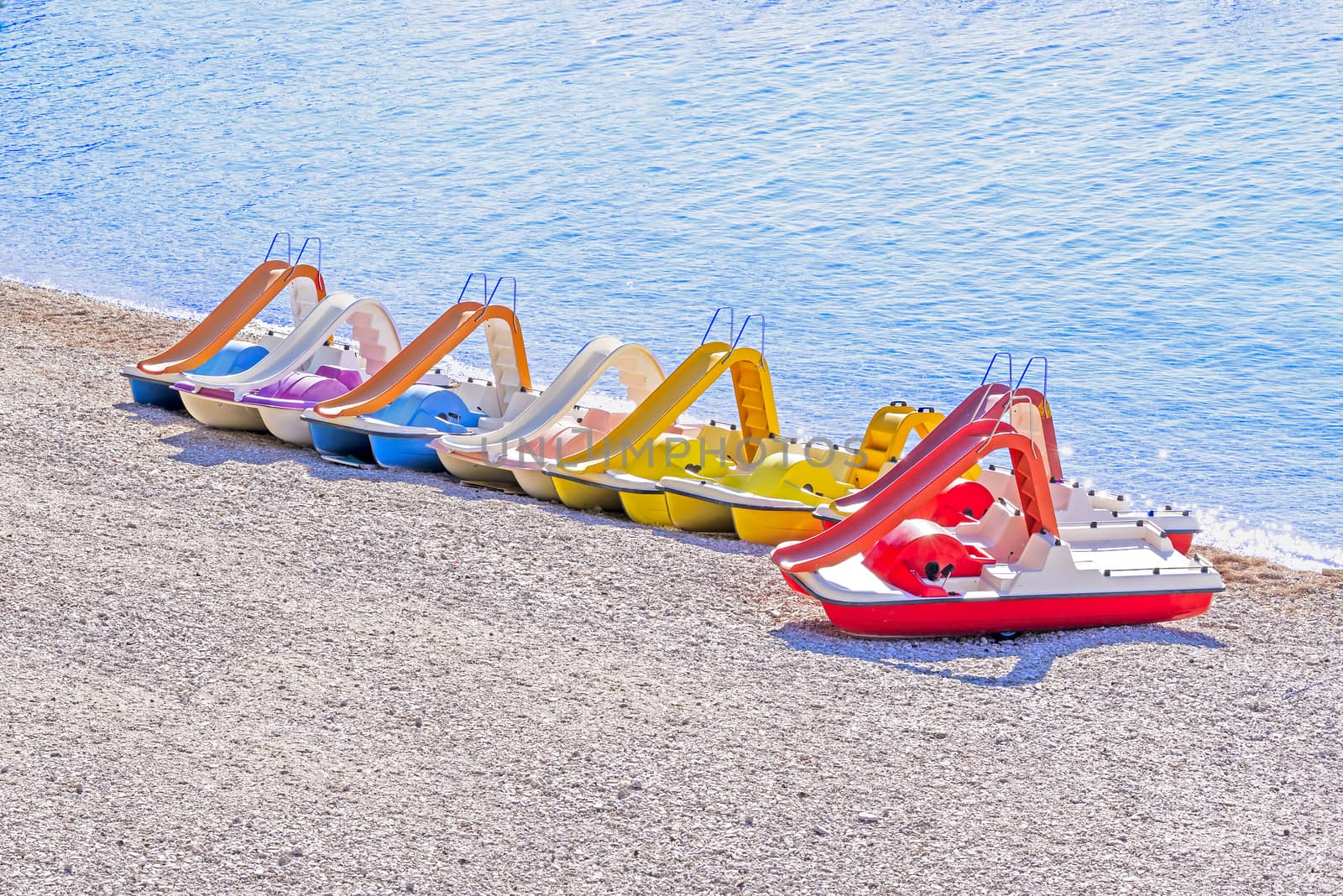 Colorful pedal boats on beach