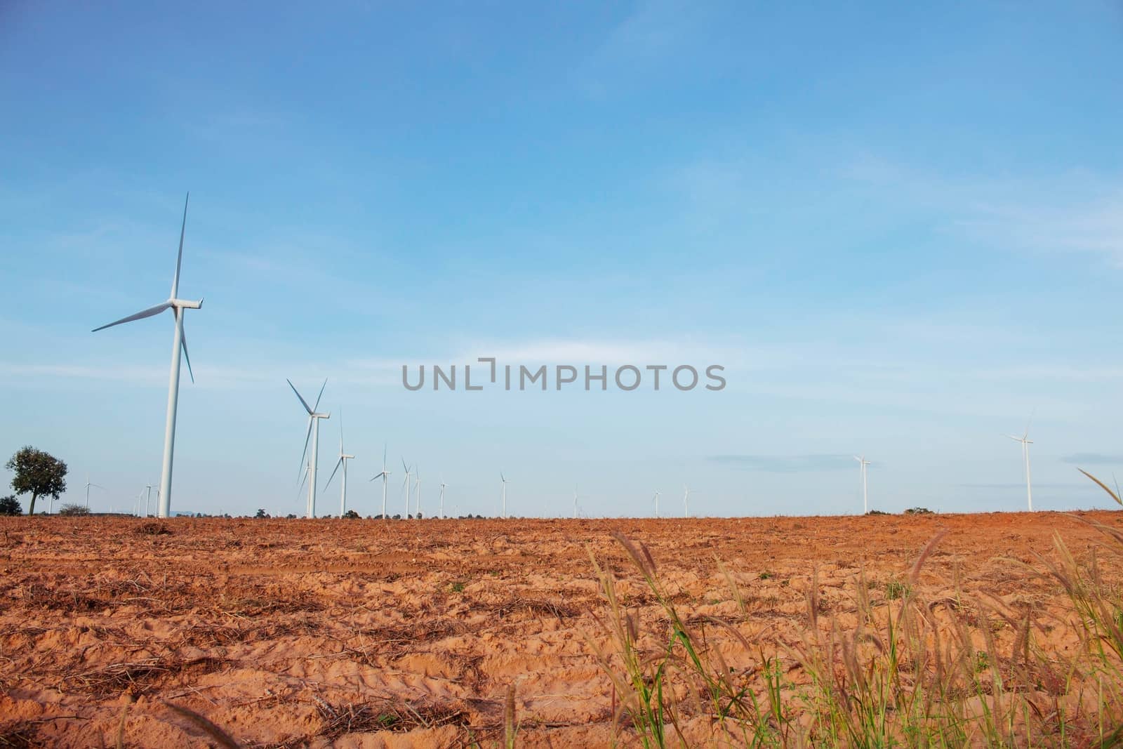 Windmill in the countryside with blue sky.