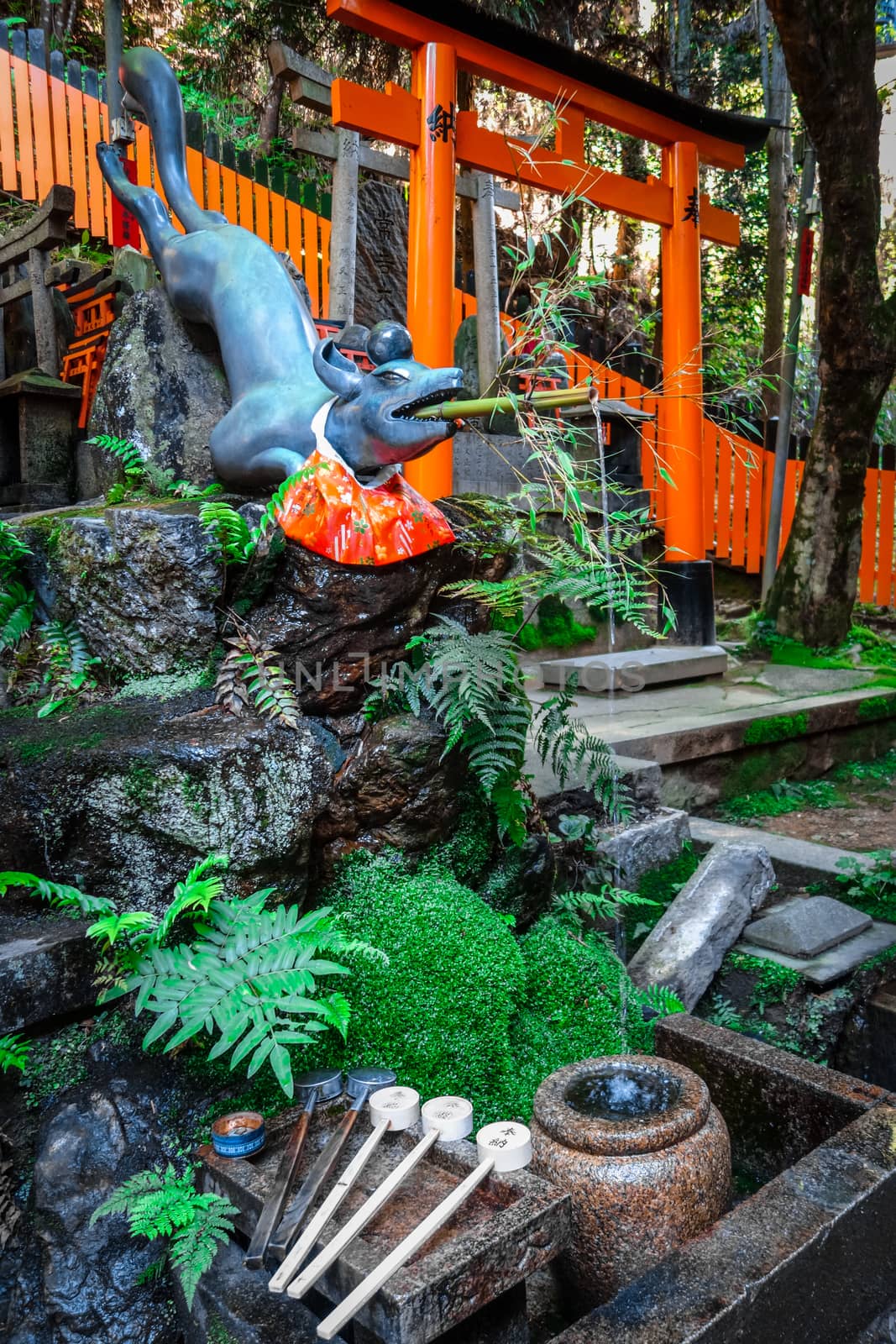 Fox purification fountain at Fushimi Inari Taisha torii shrine, Kyoto, Japan