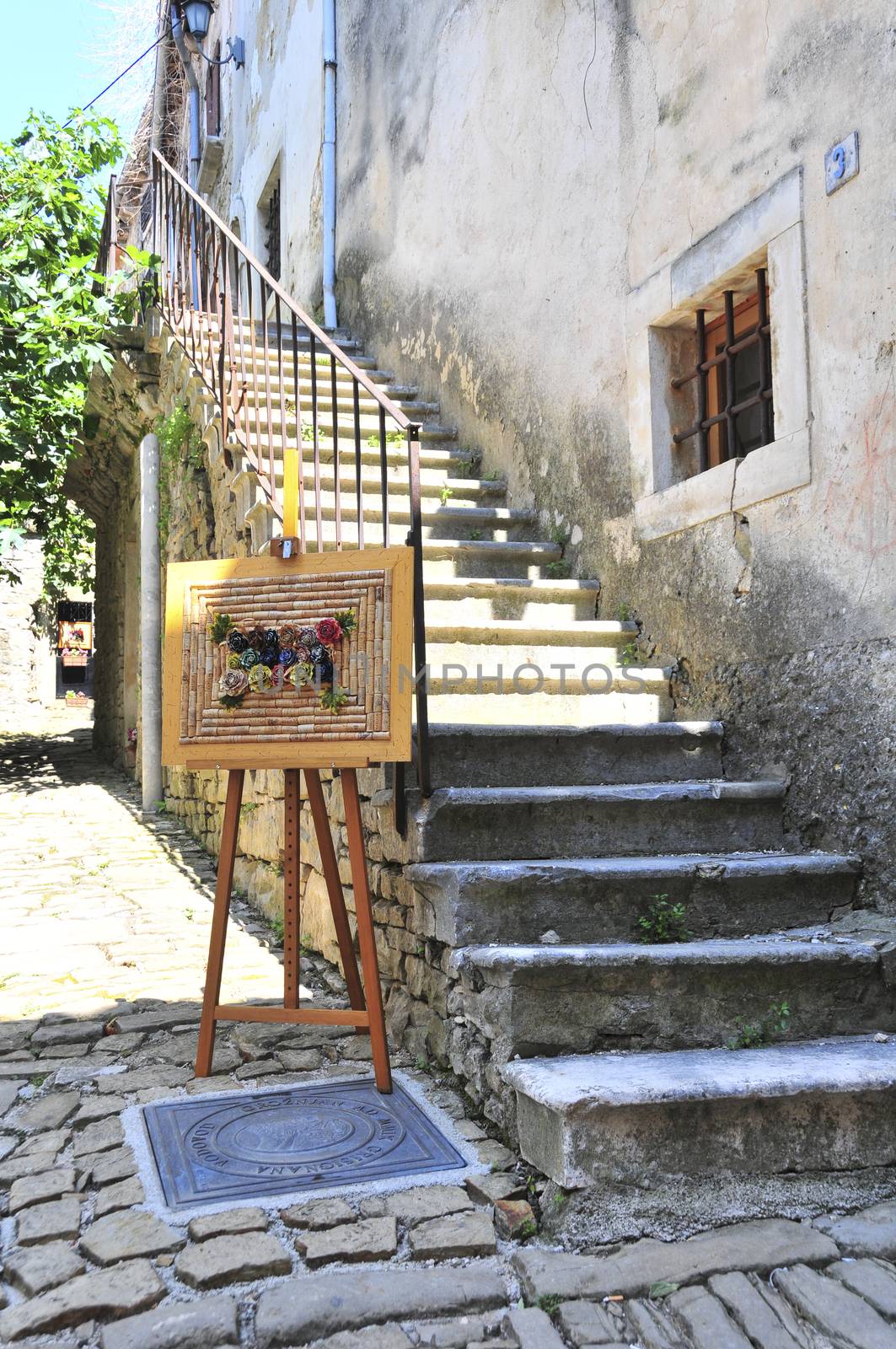 Artwork in front of stairs to artist's shop