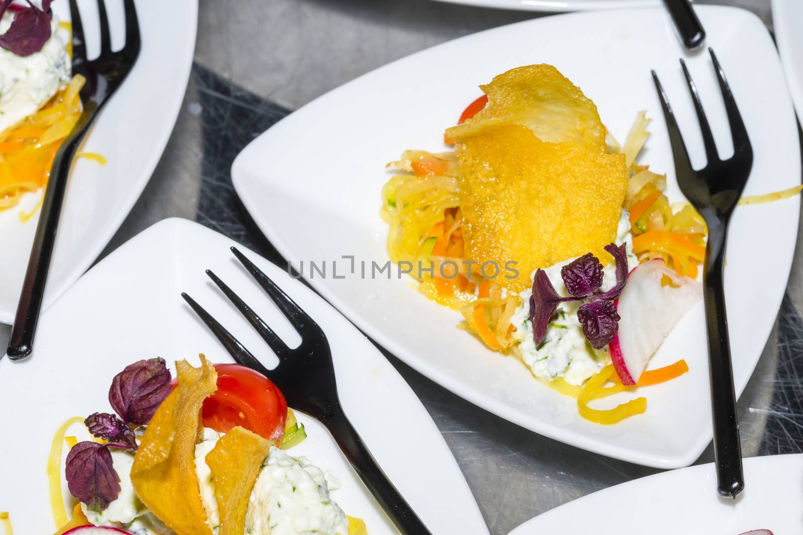 Colorful snacks (appetizers) in white cups with forks on table. Healthy diet or lifestyle concept. Low angle and selective focus. Colorful.