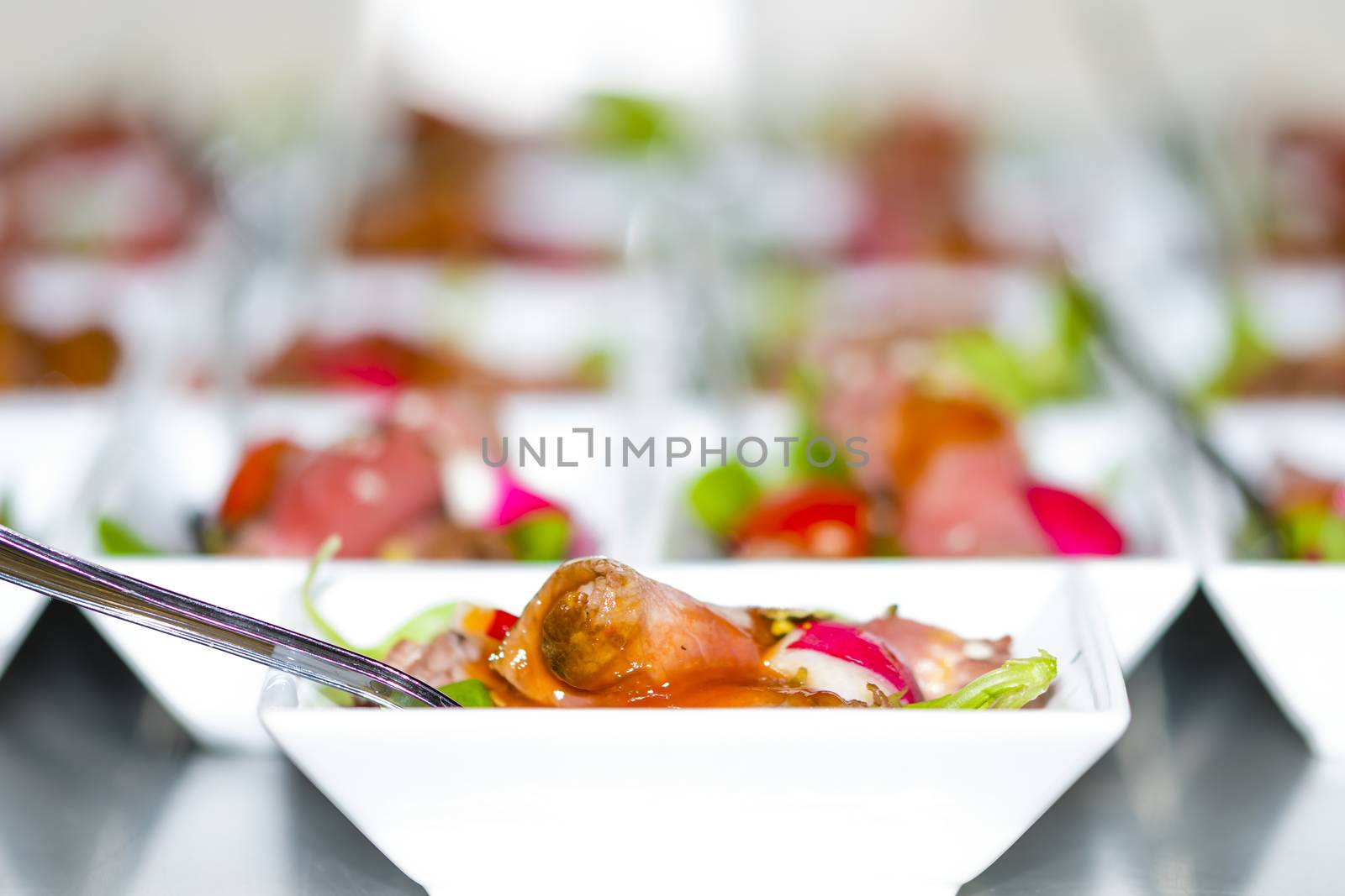 Colorful snacks (appetizers) in white cups with forks on table. Healthy diet or lifestyle concept. Low angle and selective focus. Colorful.