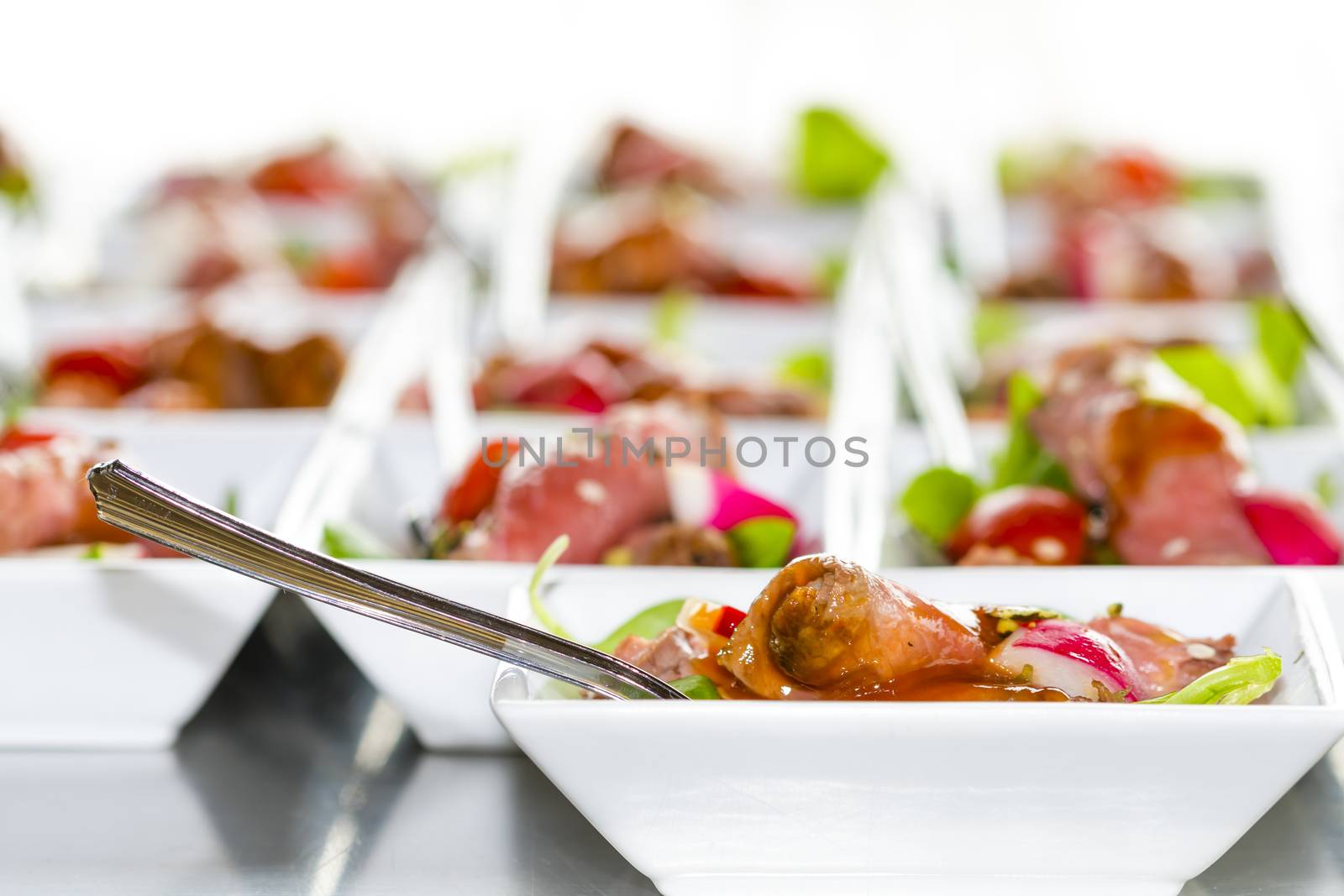Colorful snacks (appetizers) in white cups with forks on table. Healthy diet or lifestyle concept. Low angle and selective focus. Colorful.