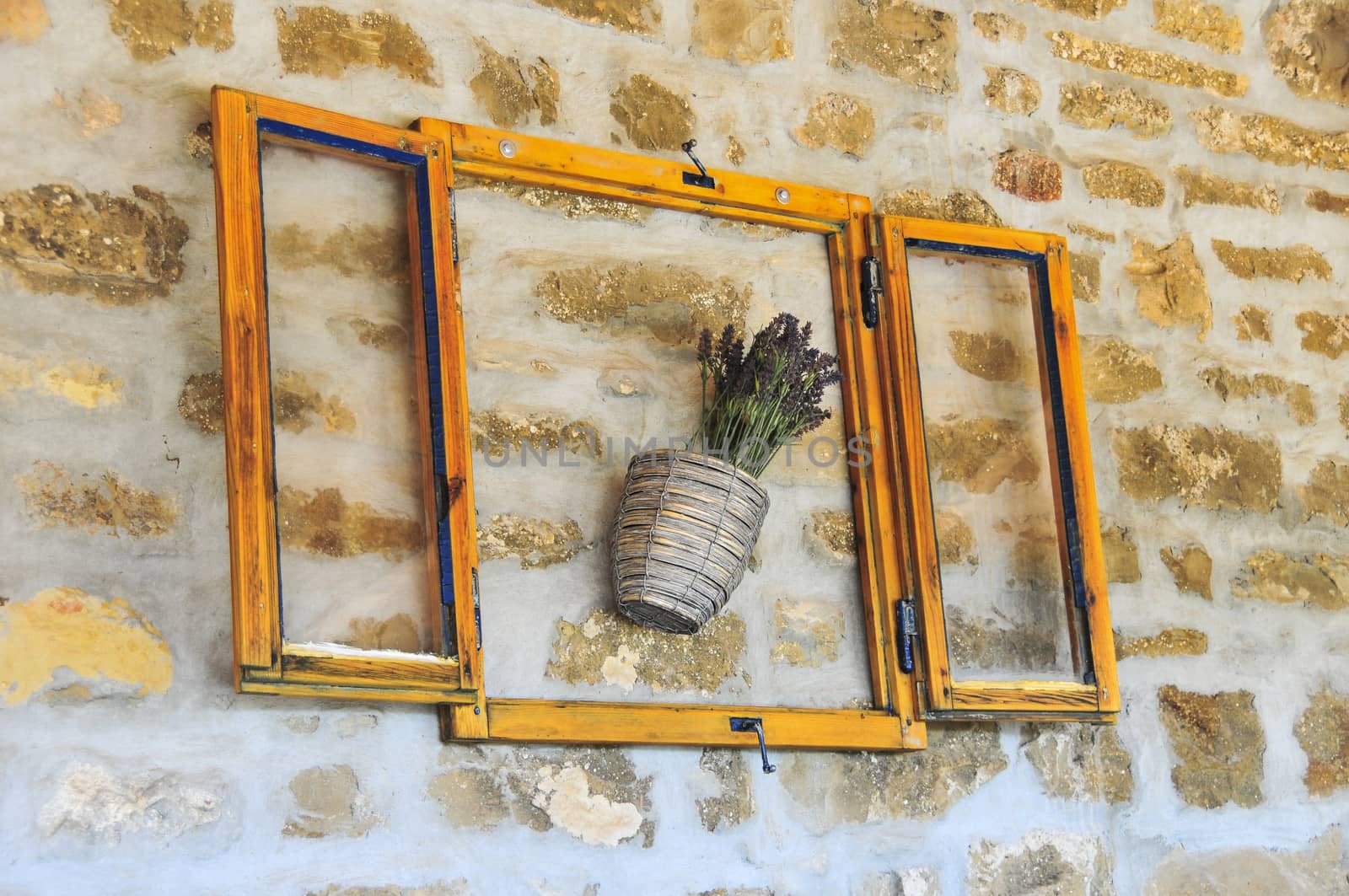 Lavender bunch in pot, in wooden frame and serving as wall decoration