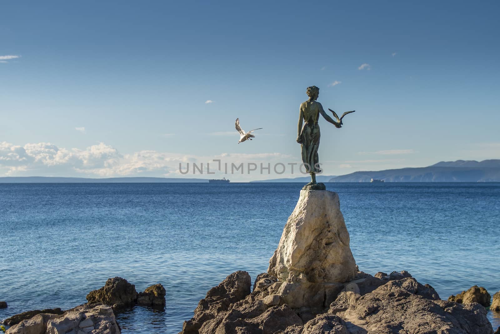 Maiden girl with seagull, statue on rocks, Opatija, Croatia by asafaric