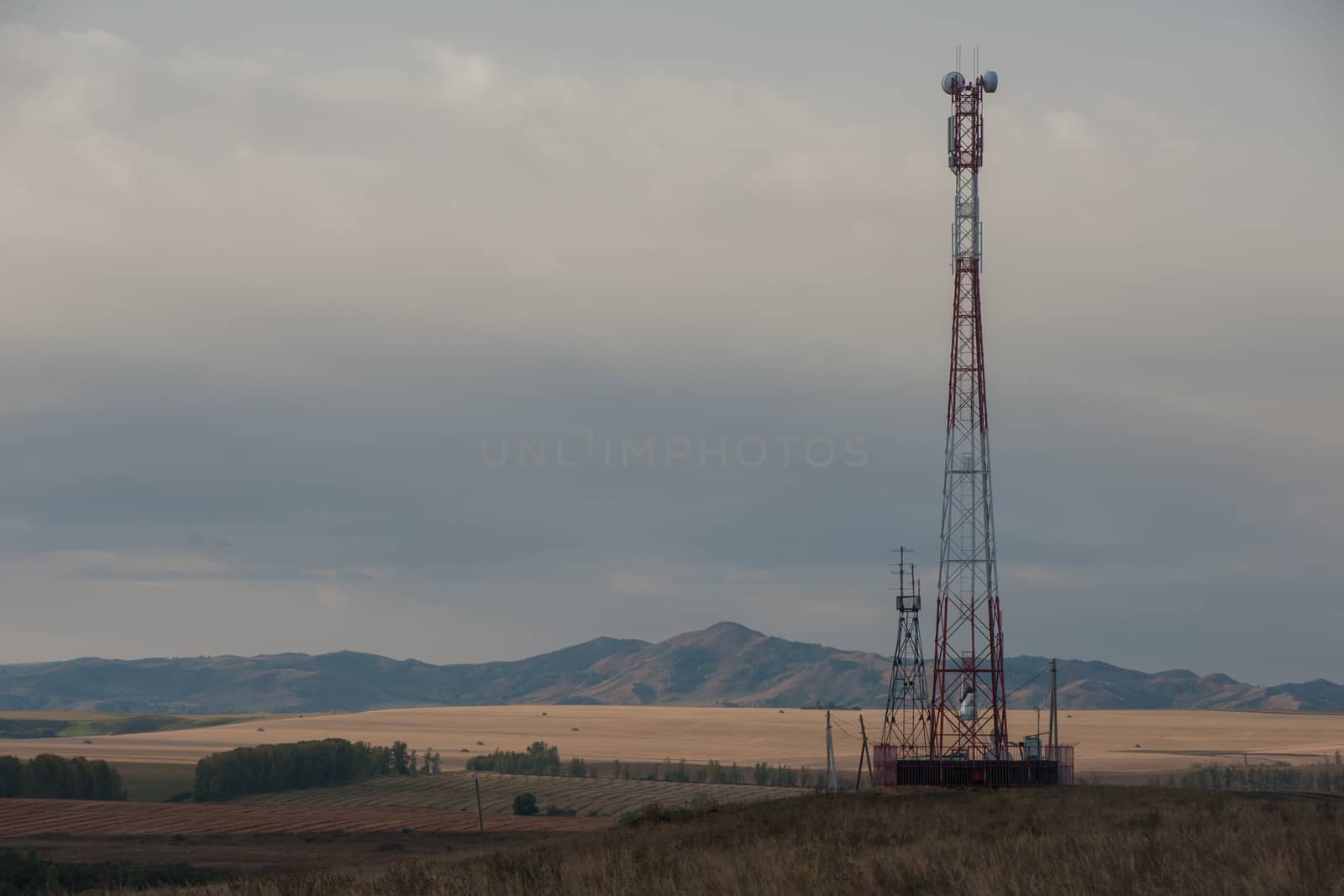 Telecommunications cell phone tower with antennas in a mountain location.