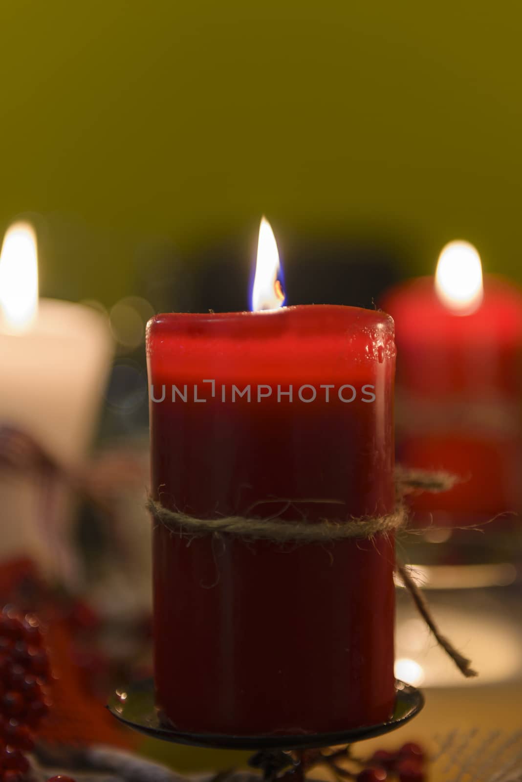 Closeup of red candle on table as part of Xmas decoration