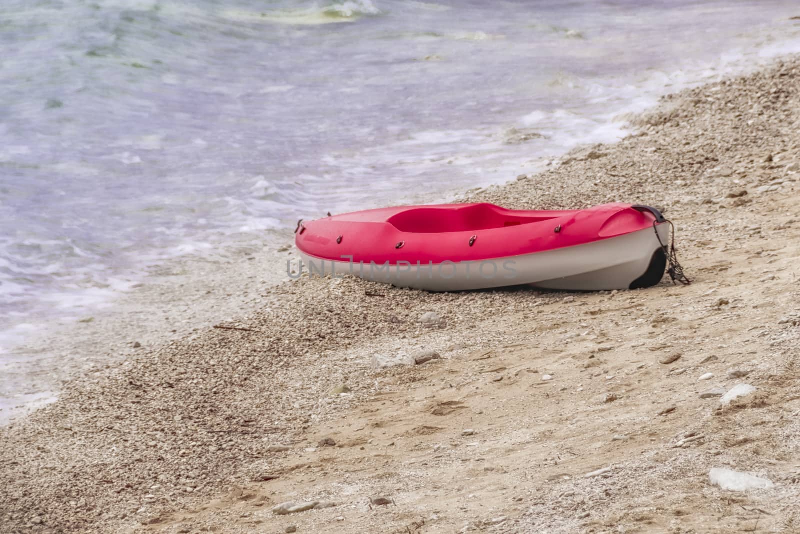 Red and white canoe on sandy beach, copyspace, nobody by asafaric