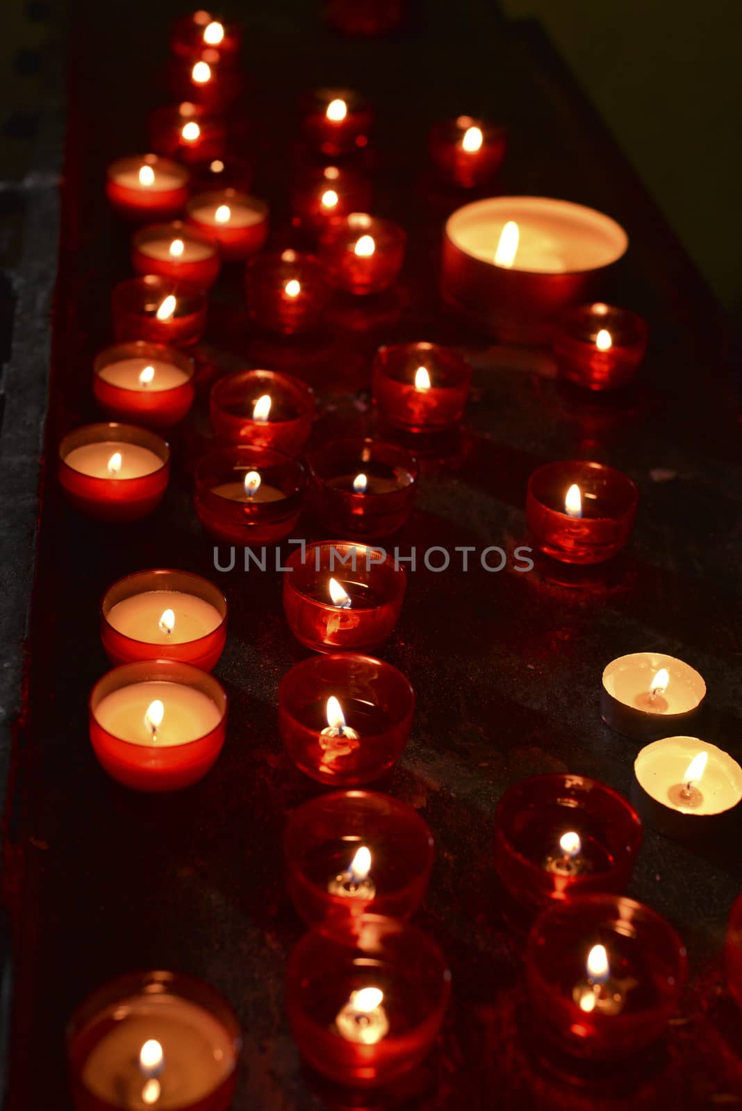 rows of red candles in church