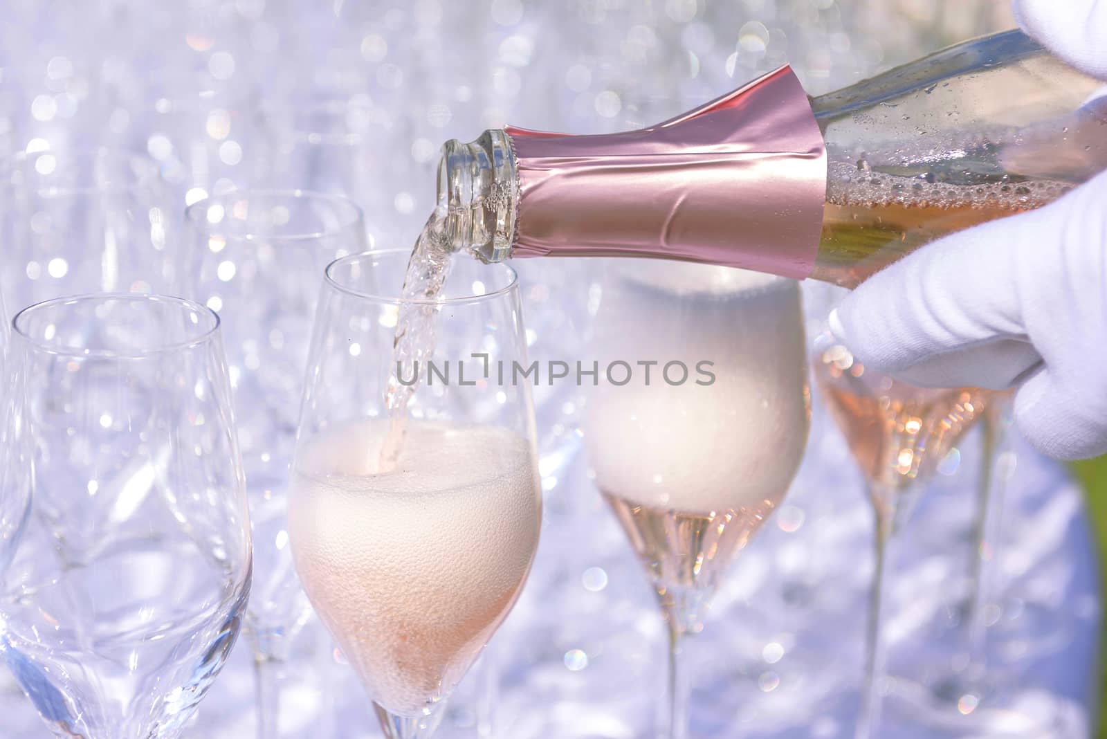 Rose champagne - sparkling wine in glasses; catering at reception