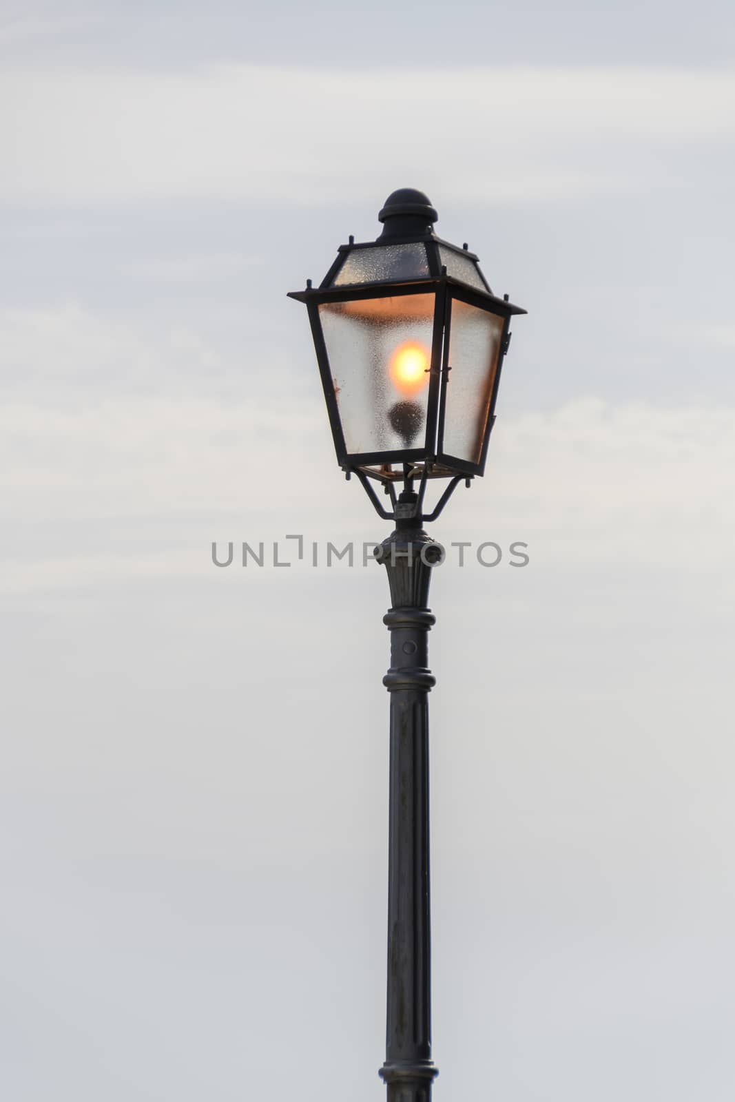 Vintage, old street lamp in classic style, made of cast iron and or metal