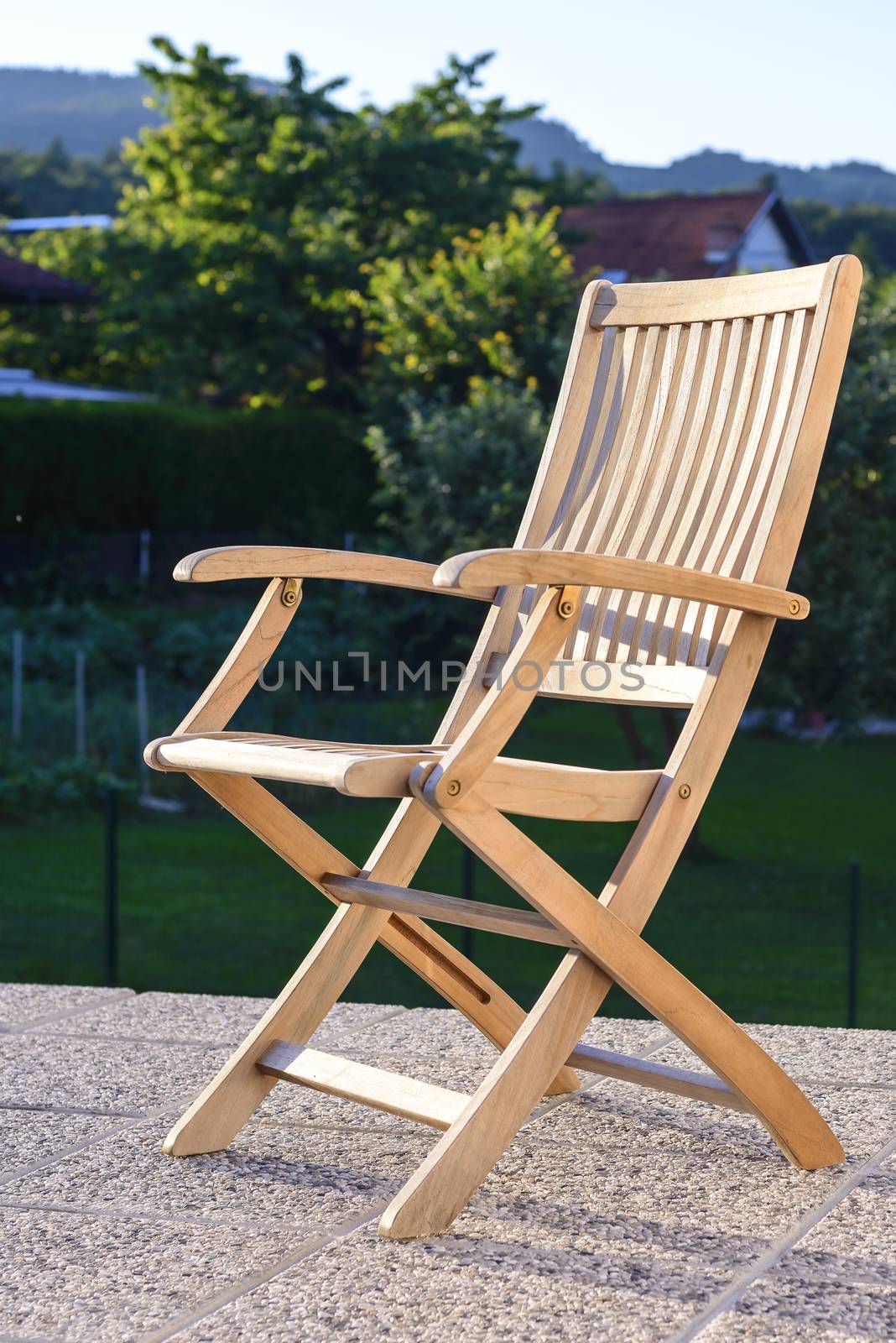 Foldable deck chair on outdoor terrace, made of teak tropical hardwood