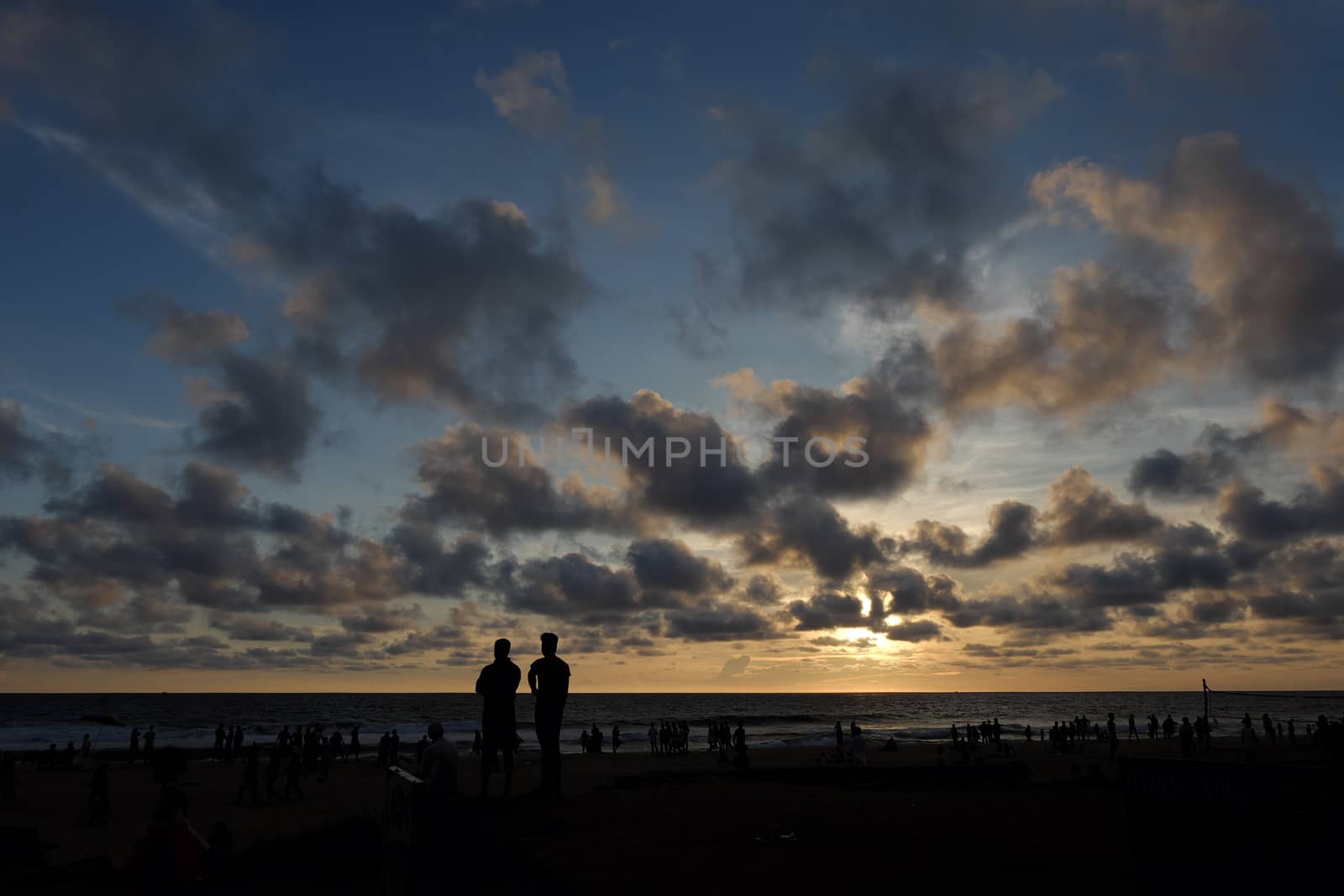 INDIA. VARKALA — MRCH 05, 2017 : Silhouettes of people watching a beautiful sunset on the beach of the Indian Ocean. Varkala town in the south of India in the state of Kerala, known for its spas.