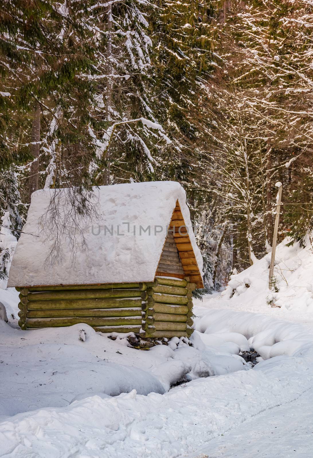 woodshed by the road in winter forest. lovely nature scenery