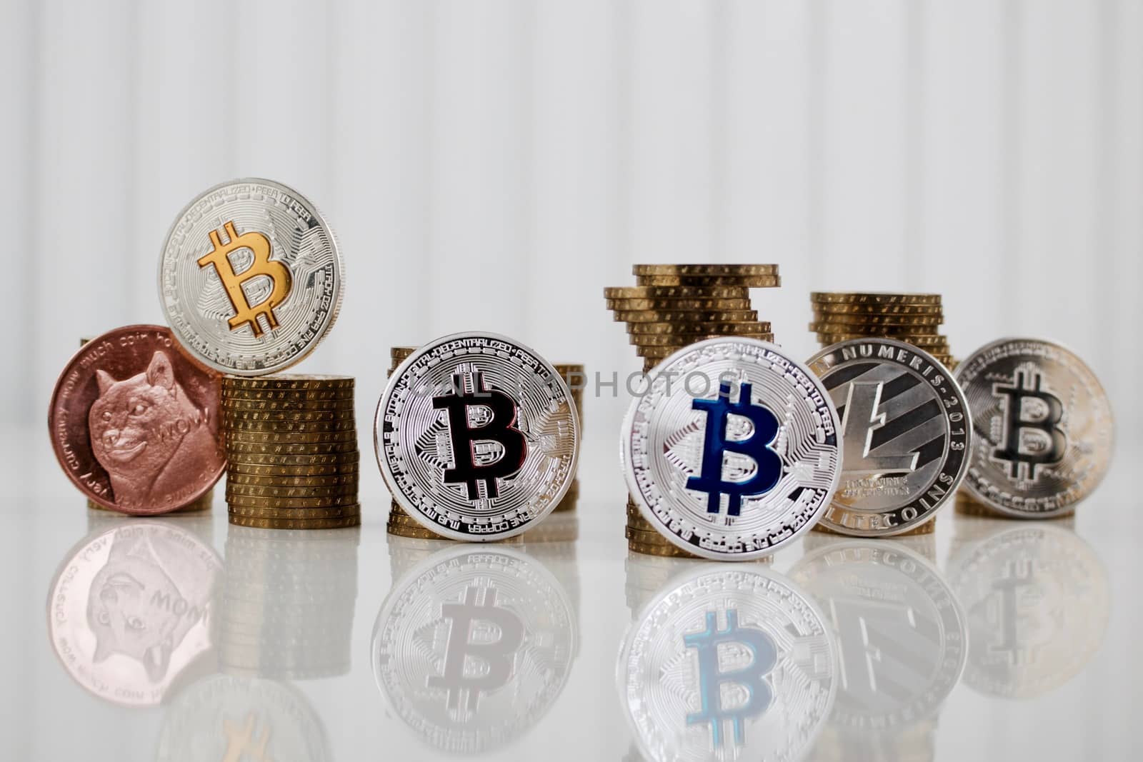 Digital currency physical silver, brass and gold coins on the white table.