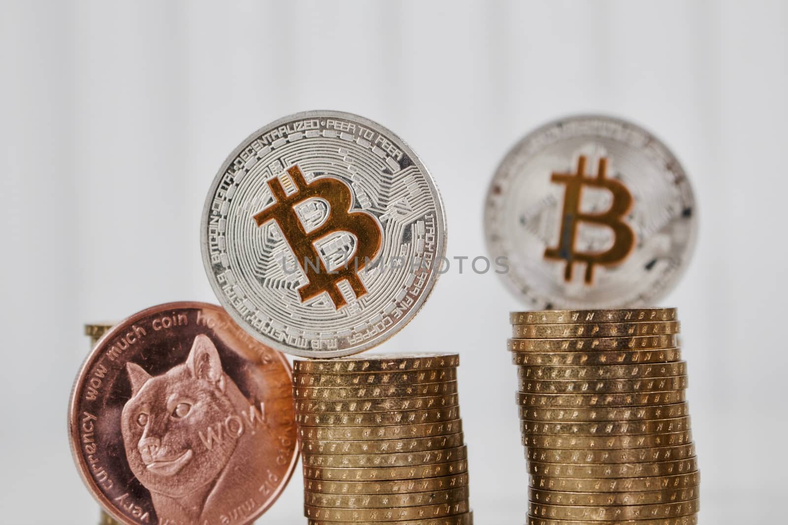 Digital currency physical silver bitcoin coins and brass dogecoin on the money.